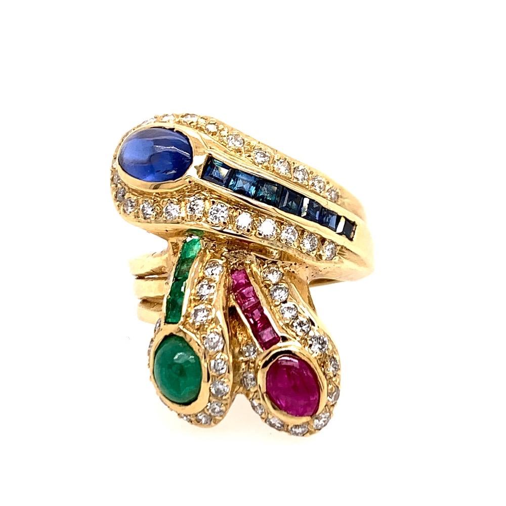 A magnificent 14k Yellow Gold Cocktail Ring set with 18 Natural Ruby, Emerald, and Sapphires weighing approximately 1.86 carats. Surrounding the colored stones are 52 natural round brilliant diamonds G in color and VS-SI in clarity weighing 0.69