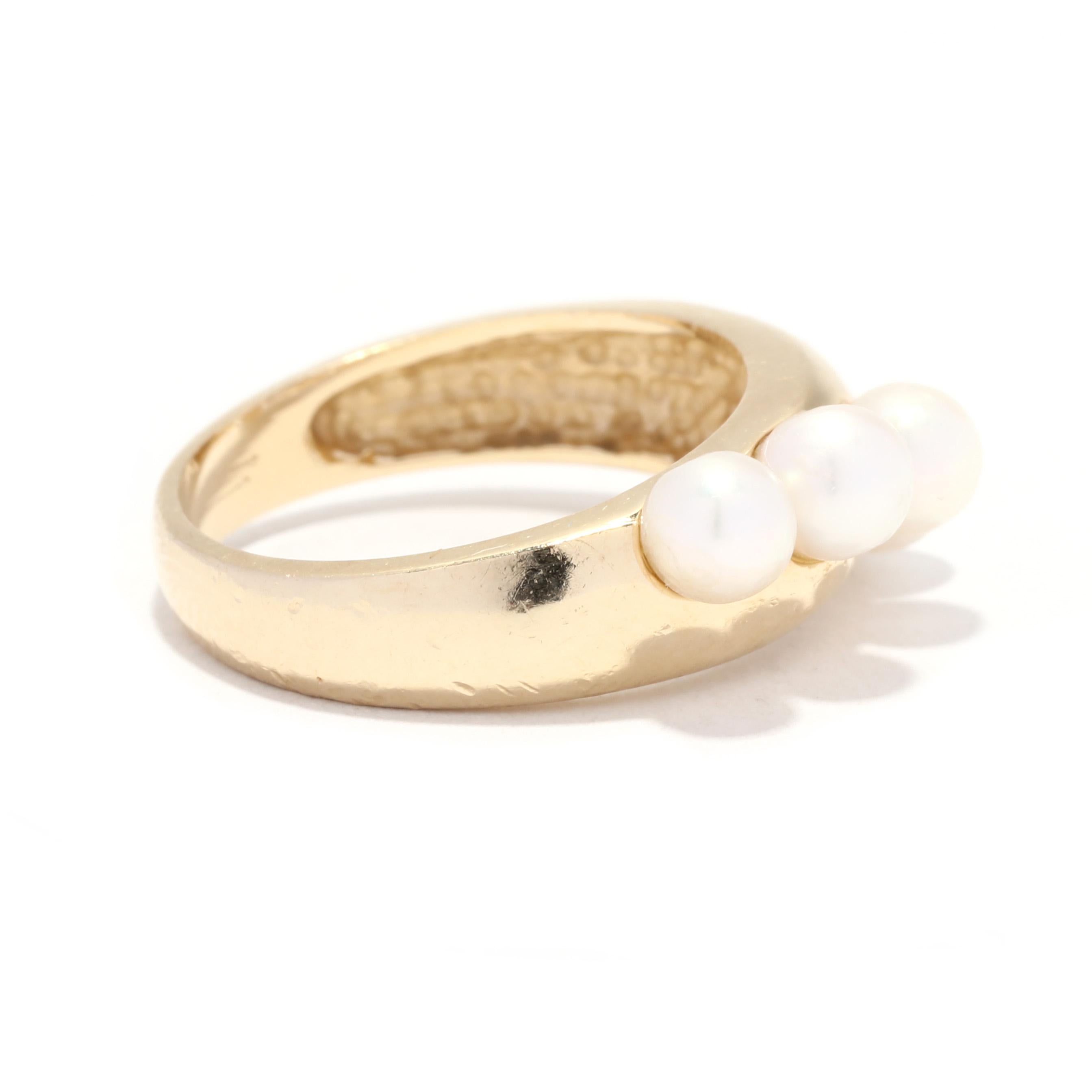 A vintage 14 karat yellow gold five pearl band ring. This modern ring features a wide tapered band with 5 round beads pearls set in a horizontal row.

Stones:
- pearls, 5 stones
- round bead
- 4.1 - 4.3 mm

Ring Size 5.75

Rise Off Of Finger: 6.5