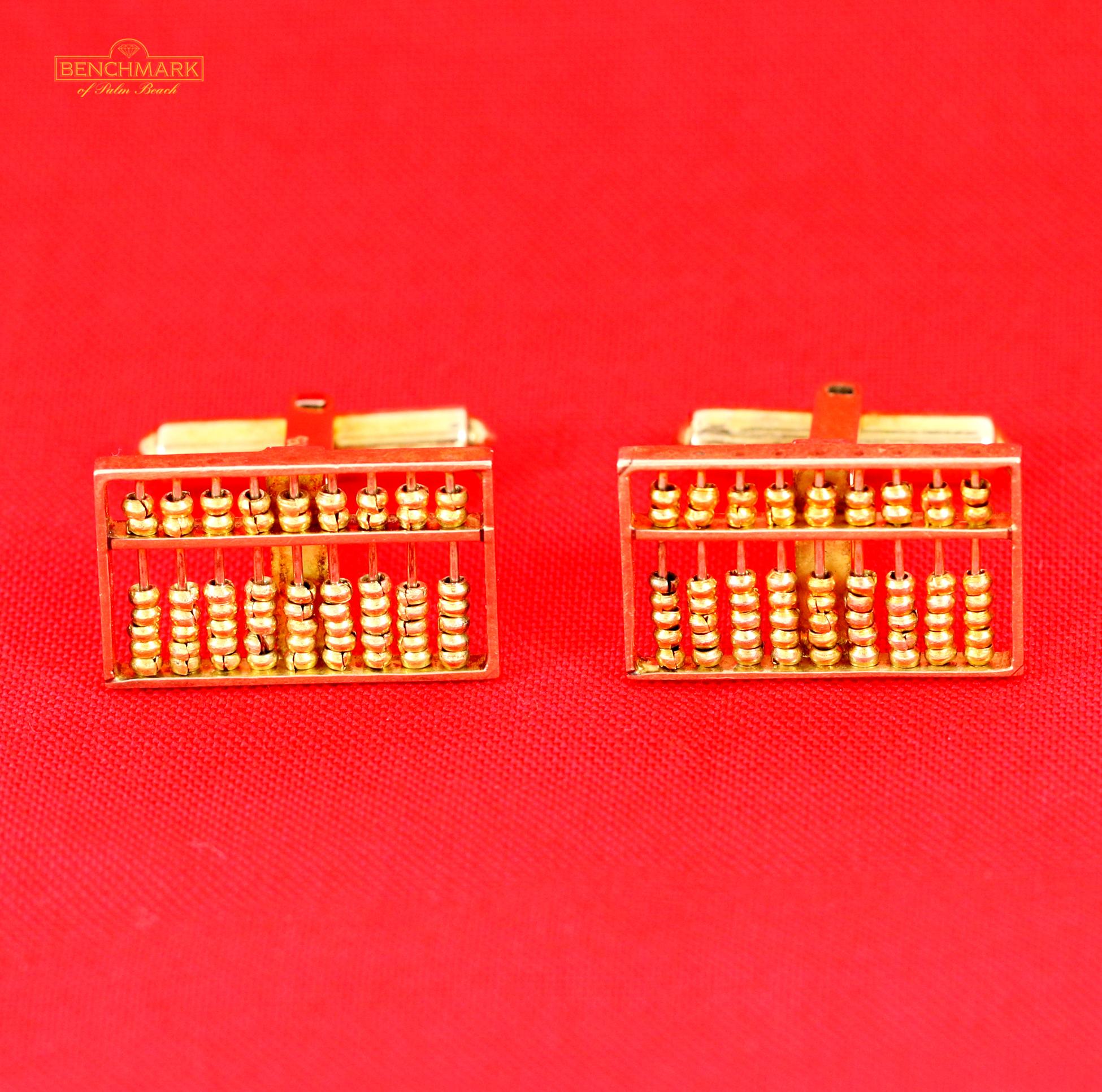 A pair of 14 Karat yellow gold cufflinks, measuring 1/2 of an inch tall, and 7/8 of an inch wide. These handsome cufflinks have a brilliant abacus design, with gold wire drawn through the frame, to facilitate the movable gold beads. Overall weight