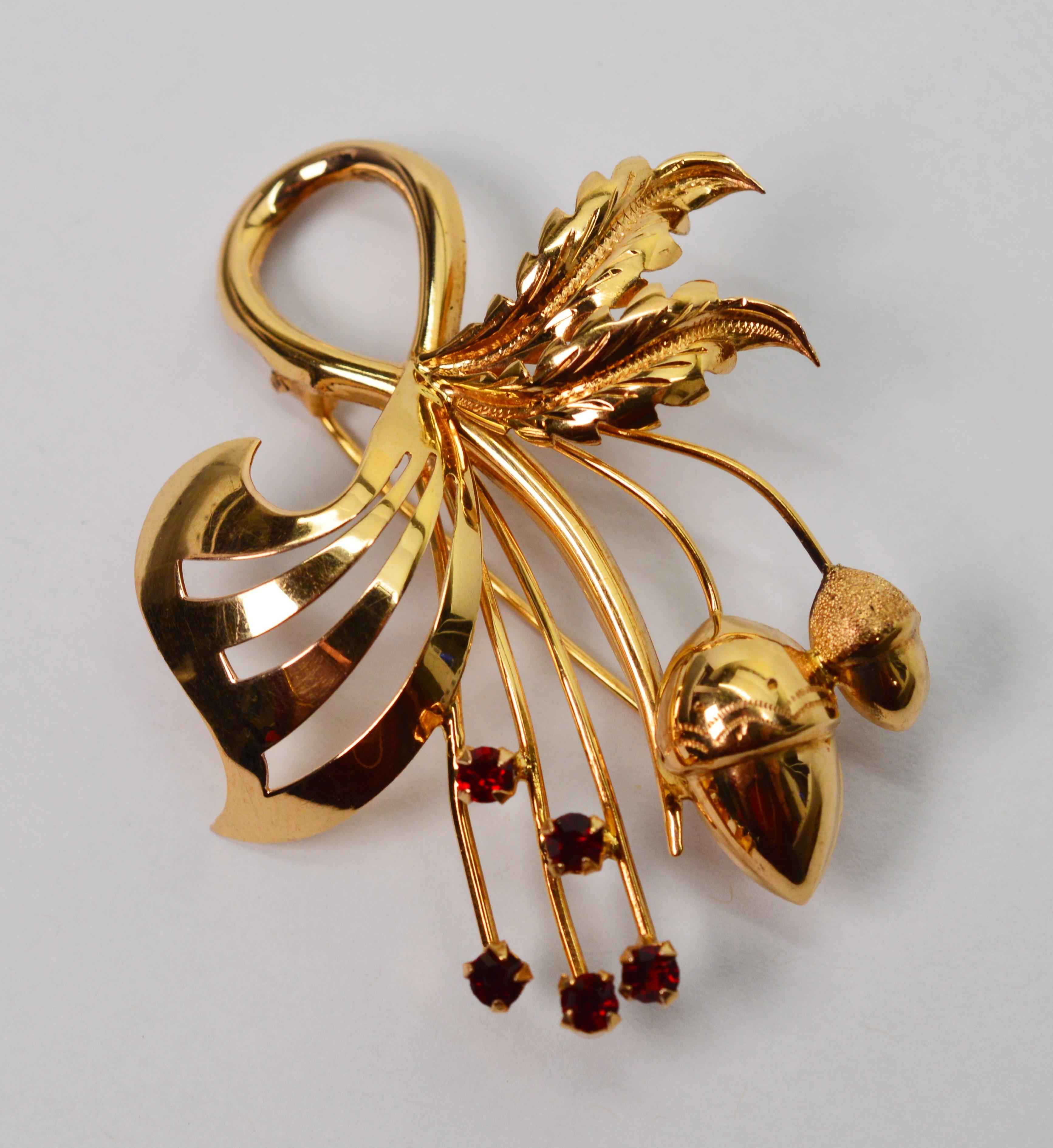 Accent your dress or lapel with this pristine Italian brooch made of bright eighteen karat 18K yellow gold. The artful spray of acorns and foliage is accented with five .02 carats of brilliant cut rubies. Stamped .750 and signed by maker. The piece