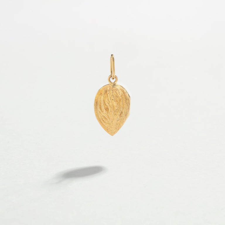 Realistic Almond Pendant yellow Gold 18k.
The almond opens as a shell and offers two identical almonds.

We love this symbol of love and unity.