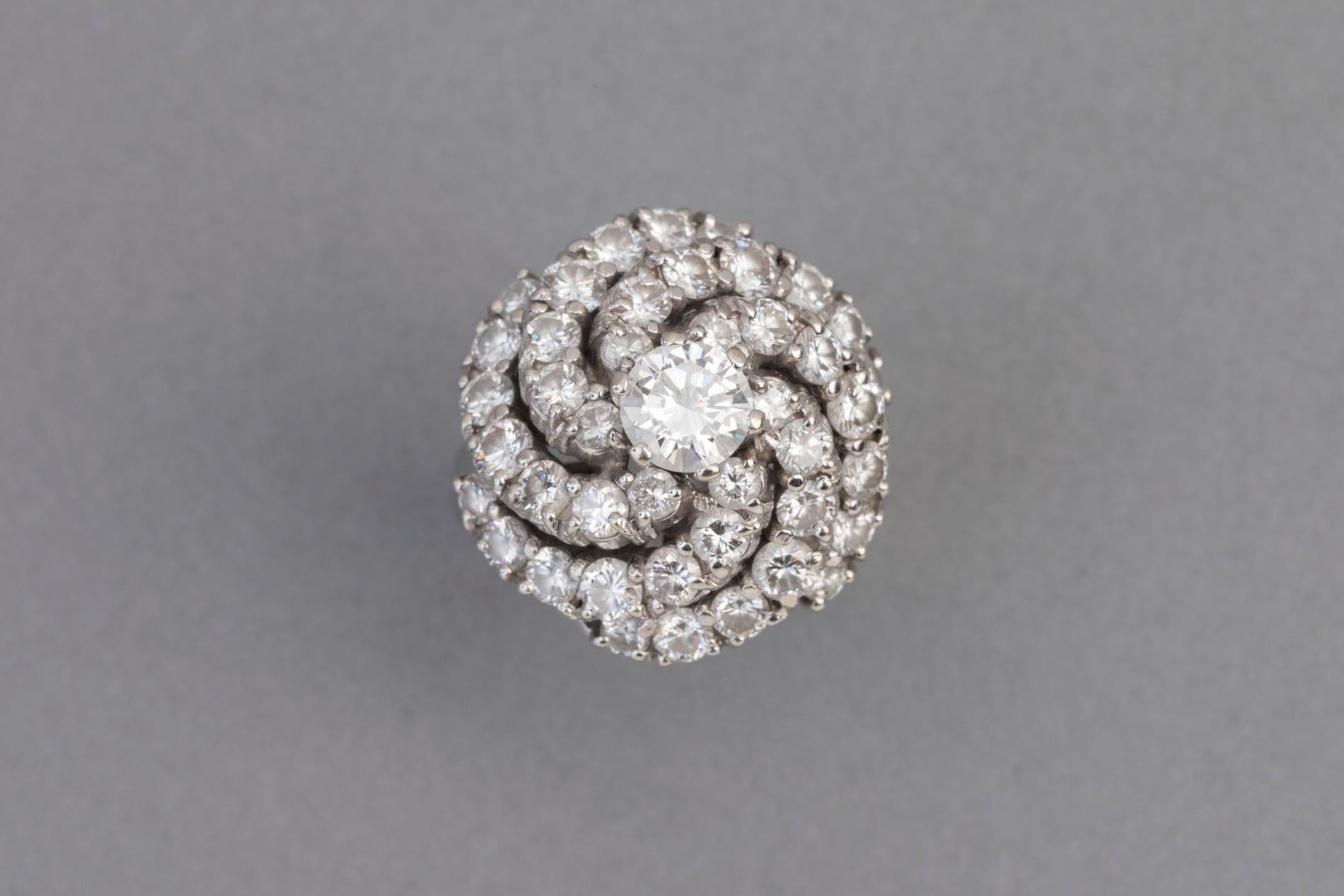 Very beautiful ring, made in France circa 1960.  
Mounted in white gold 750.   The diamonds are quality, the ring is spectacular. 
The diamonds are white colour and good clarity.  The central diamond weight 0.55 carats estimate + 2.5 carats. 