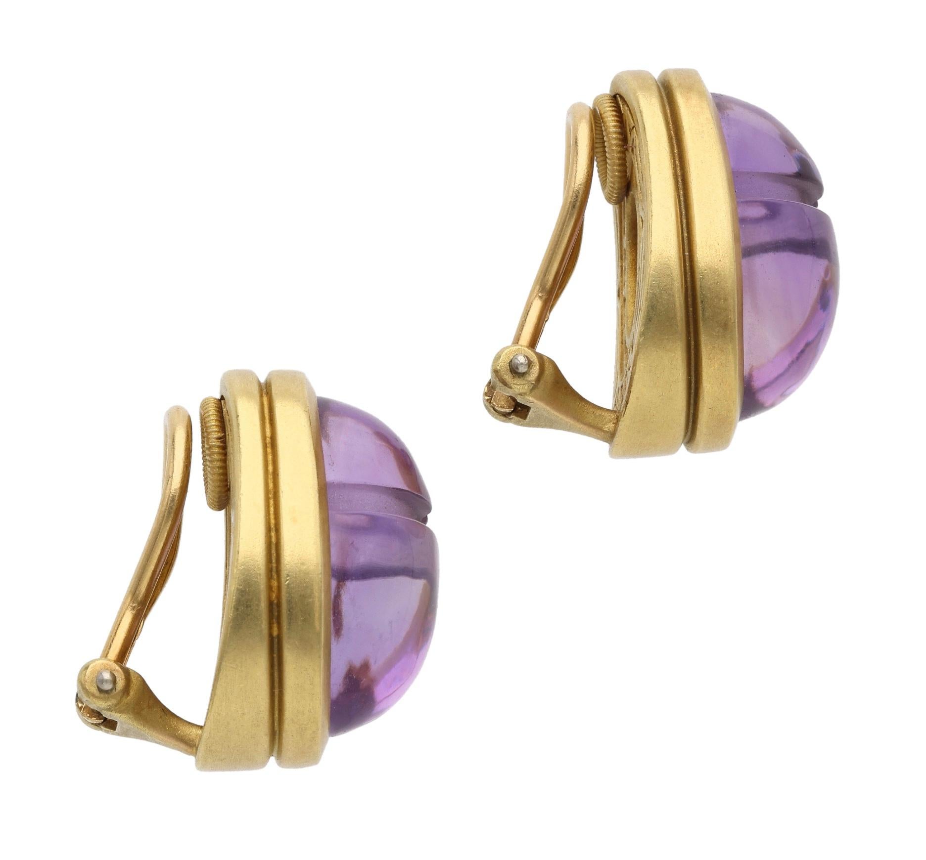 These ear clips are designed as scarab beetles, set with carved amethysts.

- Signed B Kieselstein-Cord
- 18 karat yellow gold
- Total weight 22.84 grams
- Length 1 inch

The condition report is Very Good. 