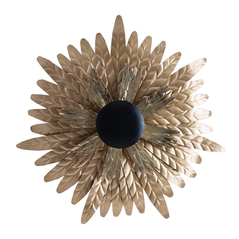 Gold and black lacquered finish metal wall lights composed of an aerial and round metal structure feathers shaped.