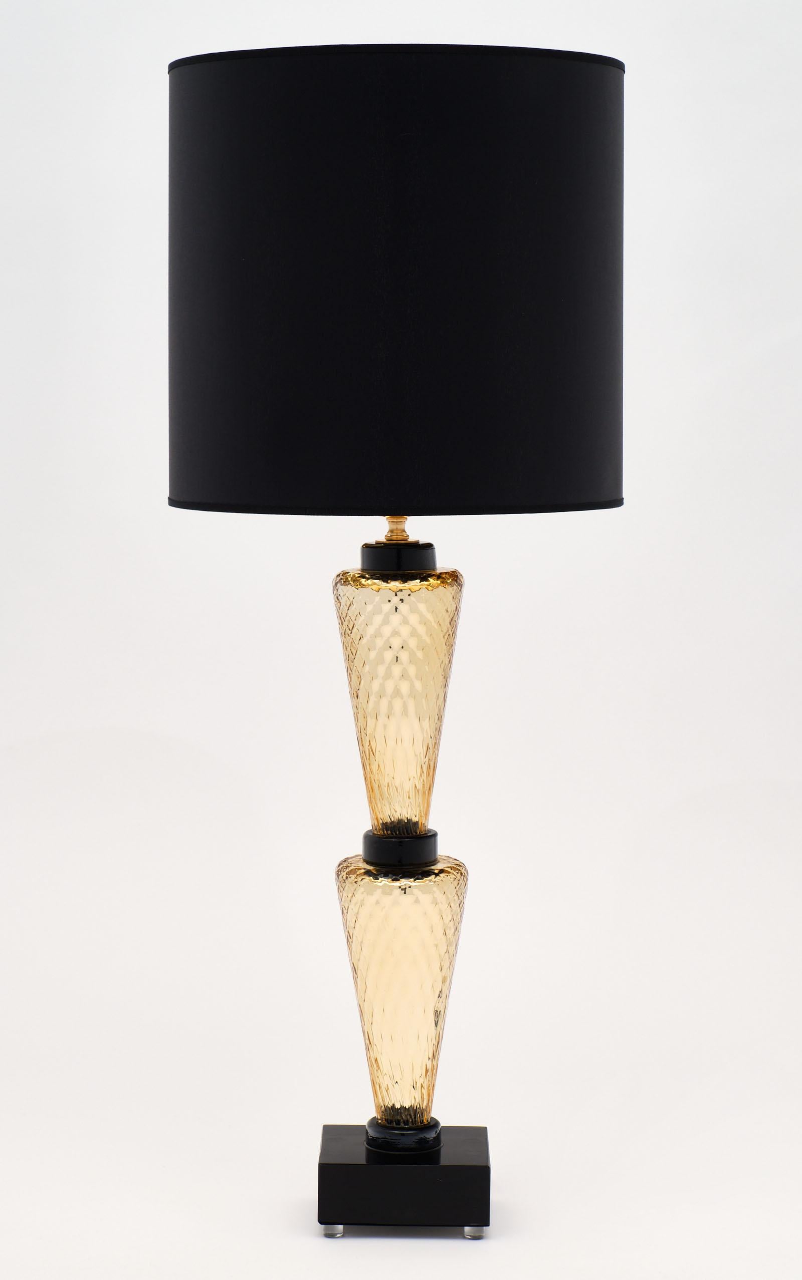 A remarkable pair of Murano glass gold and black “specchiato” lamps with a beautiful texture. We loved the very Classic and dynamic look of the hand blown glass components. The pair is signed by Alberto Dona; and the height of the glass alone is