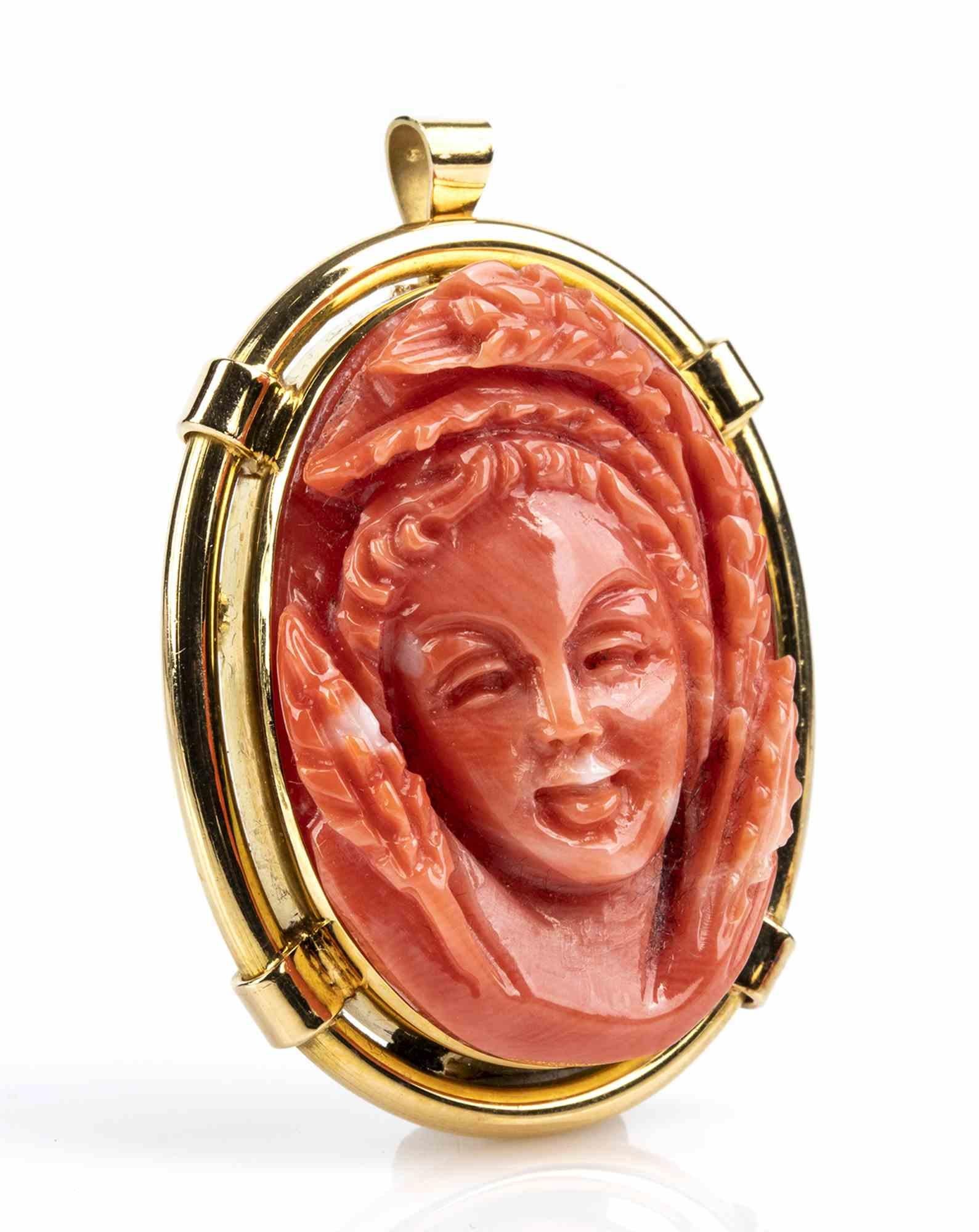 Gold and Cerasuolo coral cameo pendant

18k white gold, pendant set with Cerasuolo coral (corallium elatius) cameo depicting a female face. Stamped 