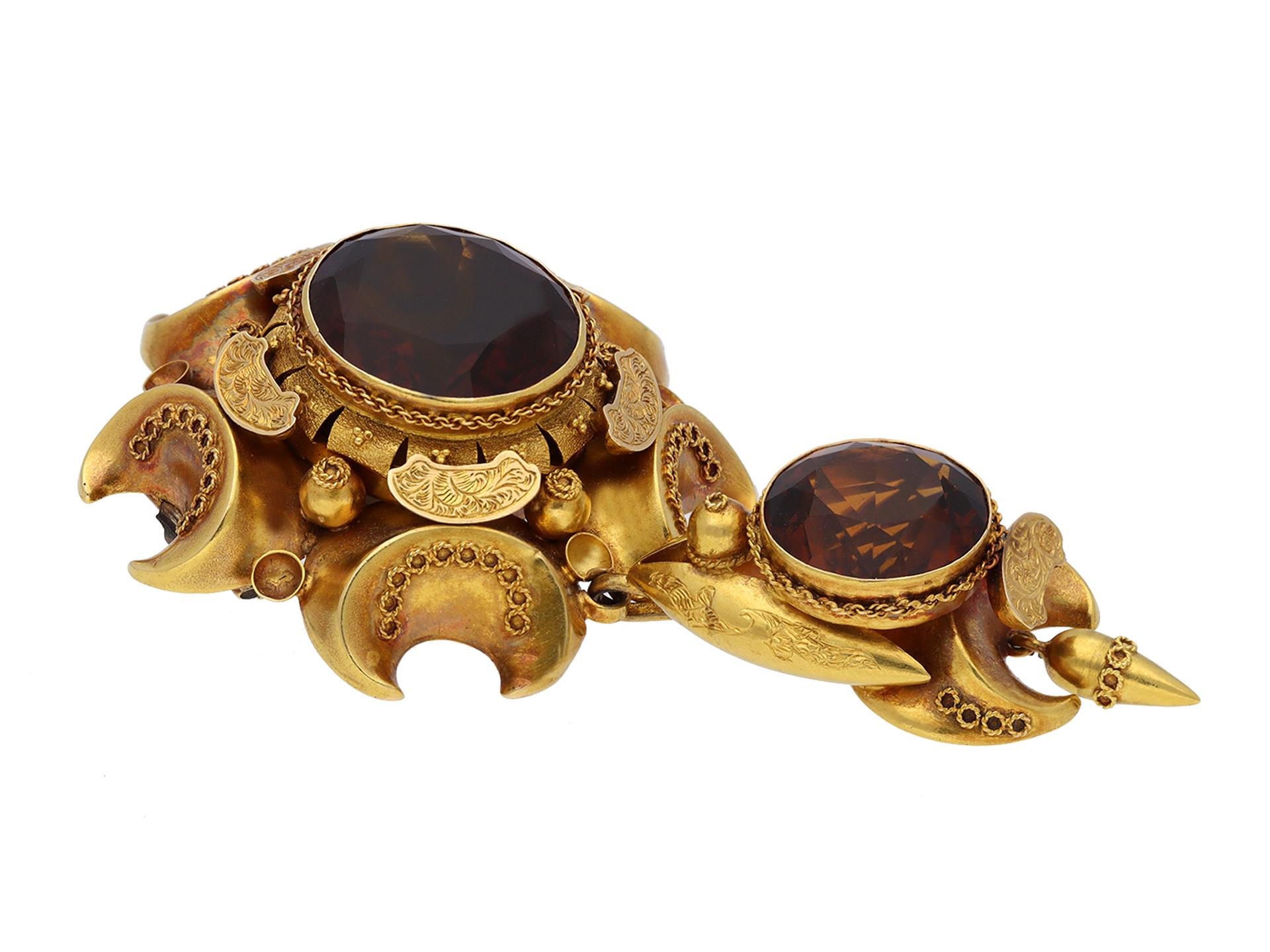 Victorian citrine and gold brooch. Set with two matching round old cut natural unenhanced Madeira citrines in closed back rubover settings, to a highly detailed brooch with crescent shape decoration, with engraved floral motifs, granulation and wire