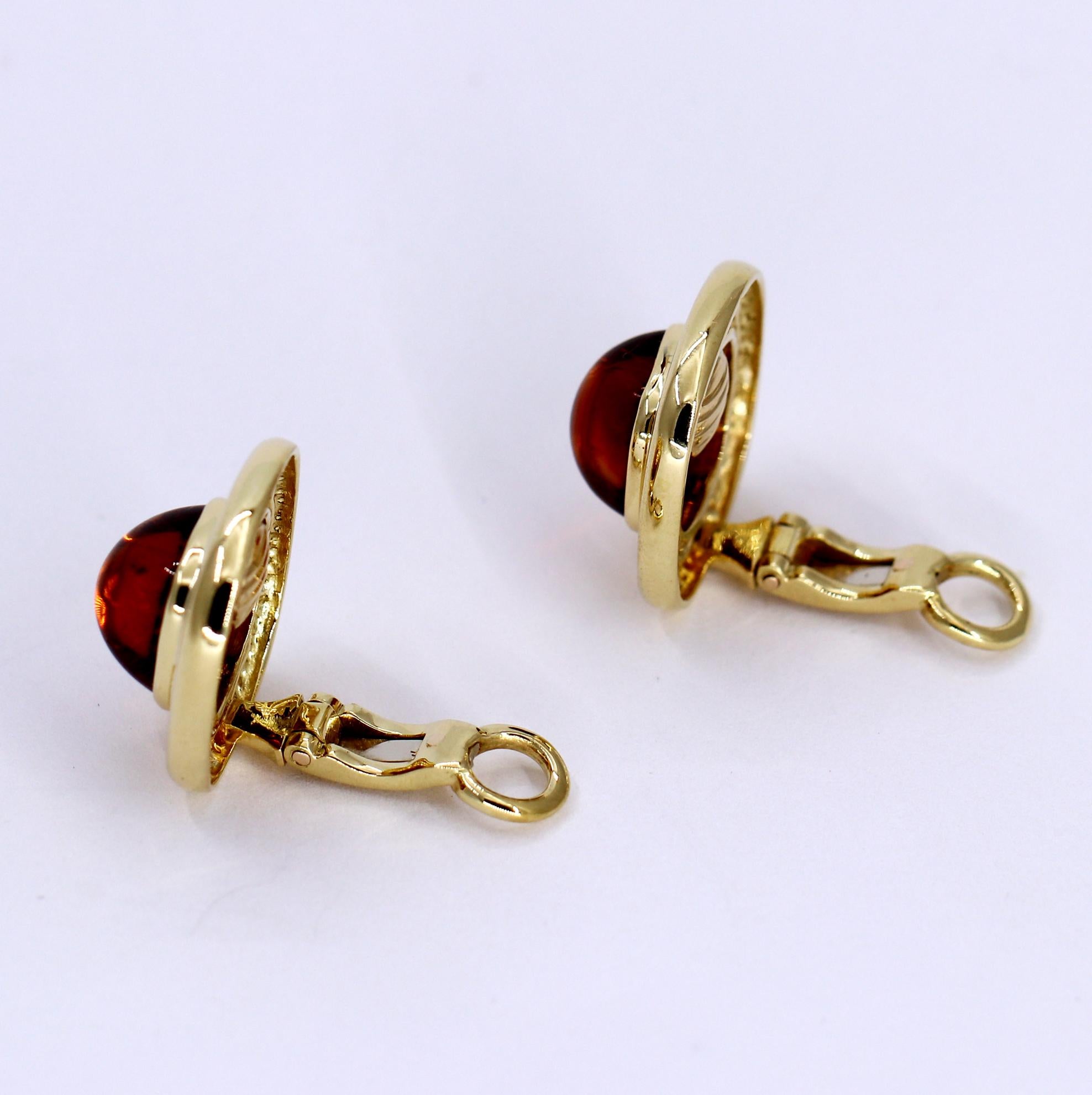 These beautifully made, high quality 18K yellow gold cushion shaped clip on earrings are set with two cushion shaped cabochon citrines. Measuring 3/4 inch by 3/4 inch, they weigh 18.1 grams overall.