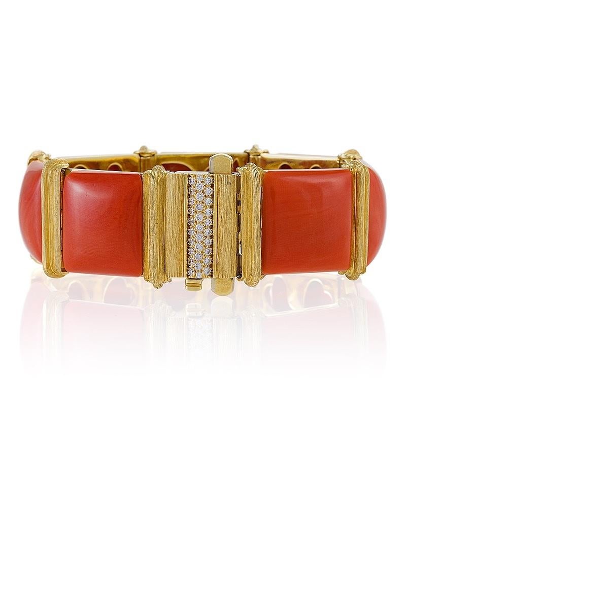 This striking contemporary coral and gold bracelet by Henry Dunay possesses all the stately glamour of a Gilded Age gem. Seven impressively large and perfectly-matched coral cabochon tablets are linked with ridged gold bars, etched with Dunay’s