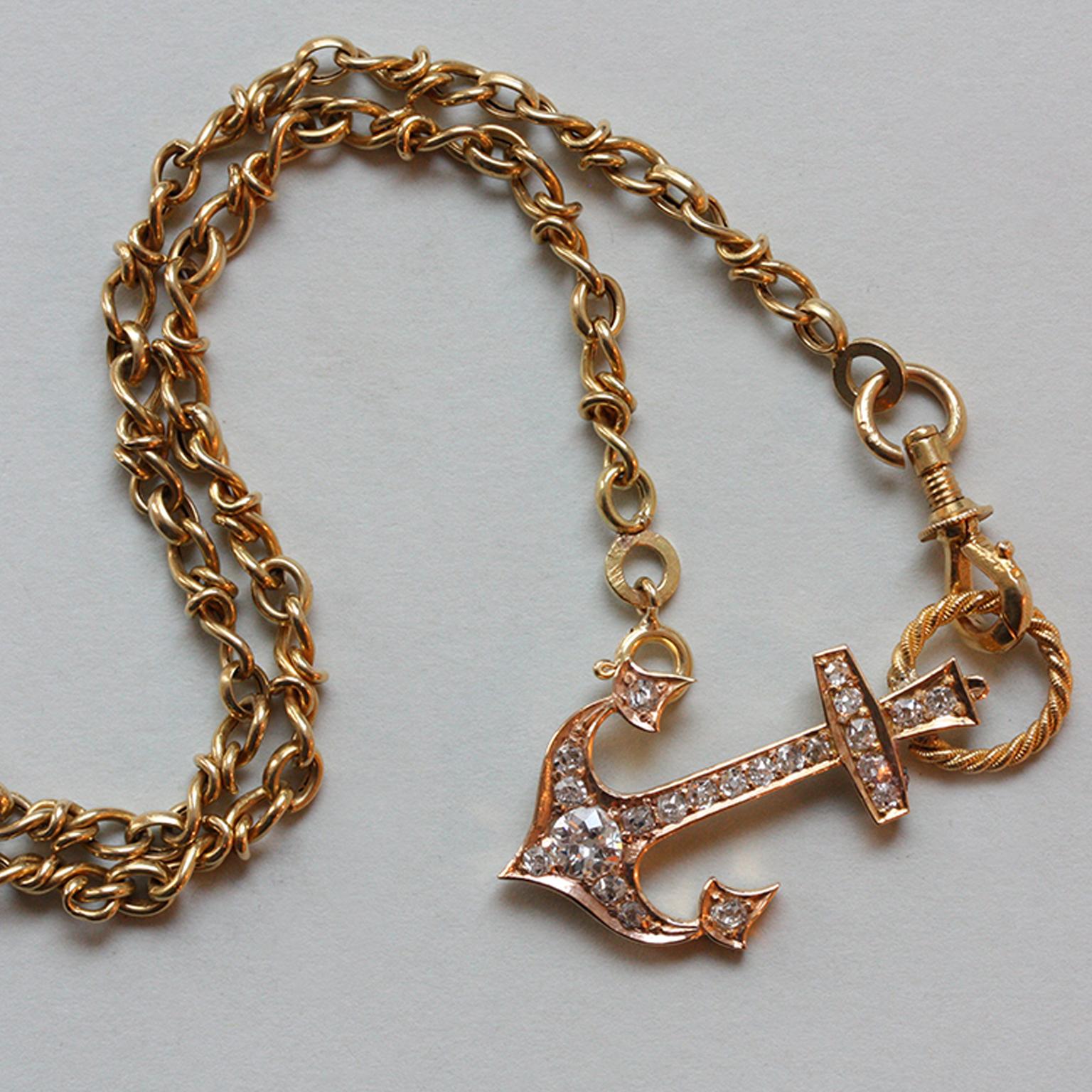 An 18 carat gold anchor pendant set with old cut diamonds (app. 0.55 carats in total), with a large hoop of twisted gold wire and a small hoop to wear the anchor either straight or rigged, with an 18 carat gold chain with knot links and a mechanical