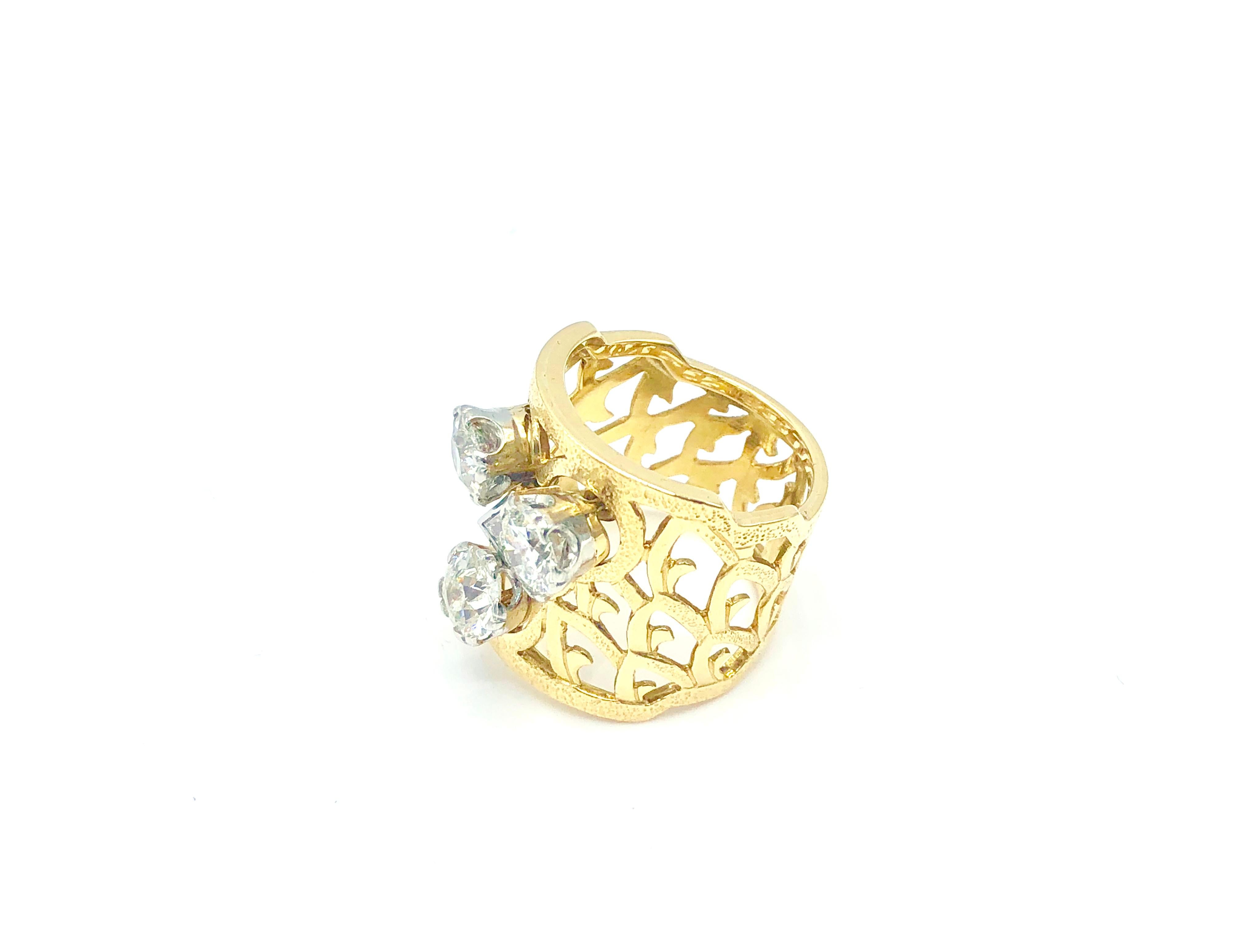 Yellow 18kt Gold and Diamond Band Ring featuring three round diamonds 
