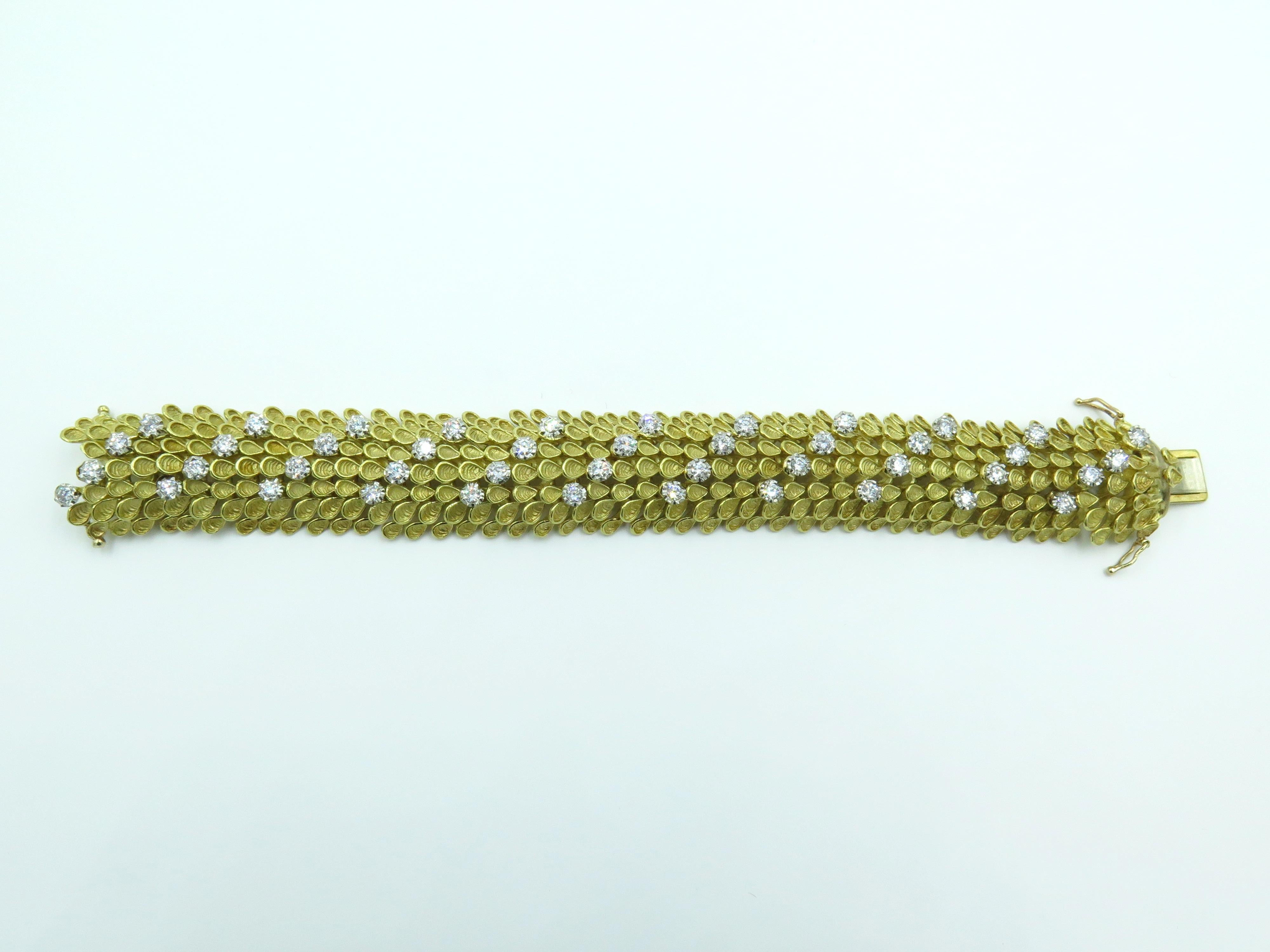 An 18 karat yellow gold and diamond bracelet. Circa 1960. Designed as an articulated bombe band of foliate design, enhanced by circular cut diamonds. Forty four (44) diamonds weigh approximately 3.08 carats. Length is approximately 7 inches, gross