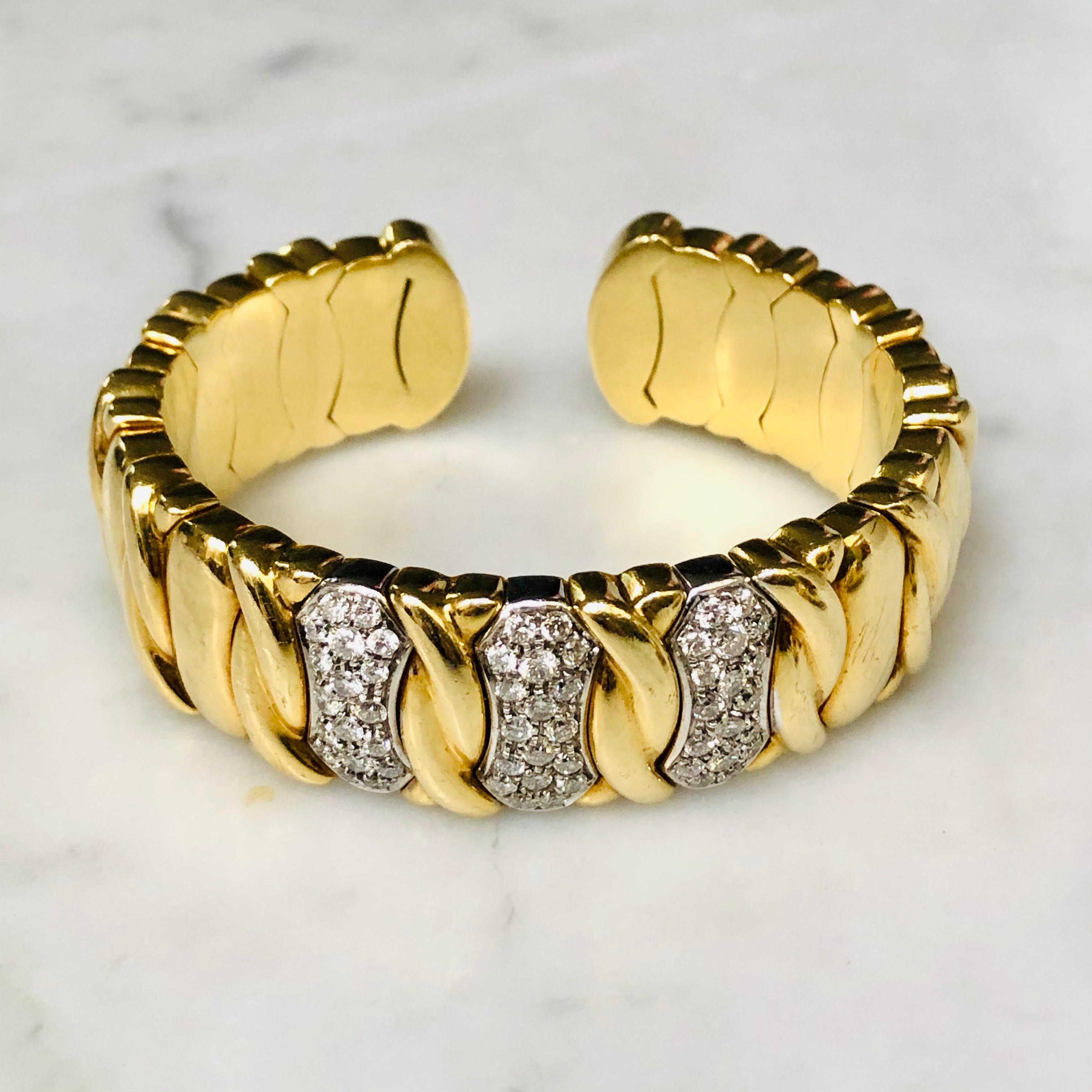 Gold and diamond set cuff bracelet. Heavy 18ct gold bangle with diamond twist motif to create the perfect wrist ornament. 

18ct Yellow Gold 
Set with 2.65 carats of Diamonds 
Internal diameter 5.6cms 
Bracelet width 1.9cms 
Weight 91 grams 
