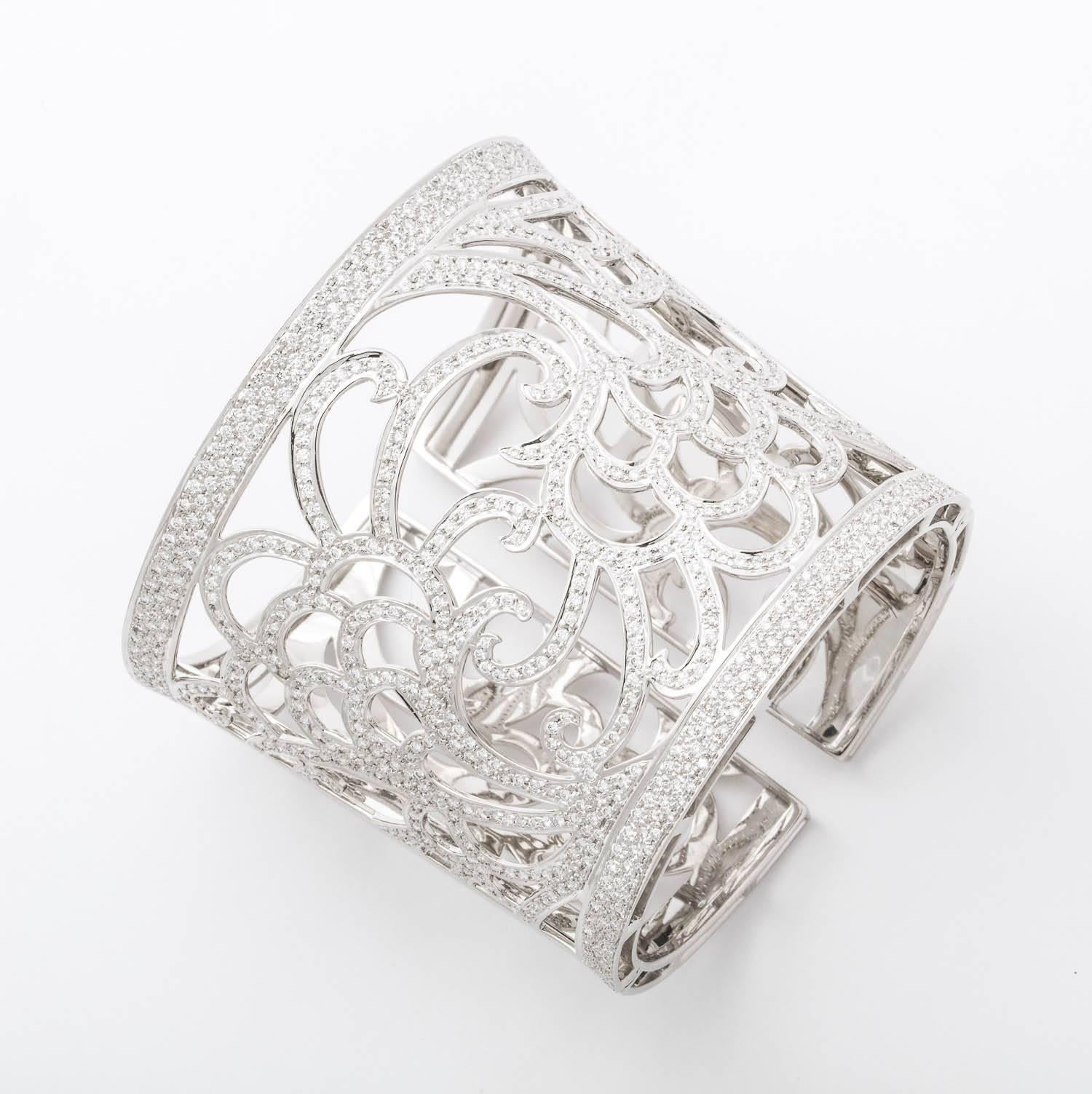 18 Karat white gold and diamond tapered cuff bracelet containing 500 full cut diamonds total weight 7.33 carats.  121.7 grams 18k gold,  Hand pierced and and set in a beautiful floral pattern