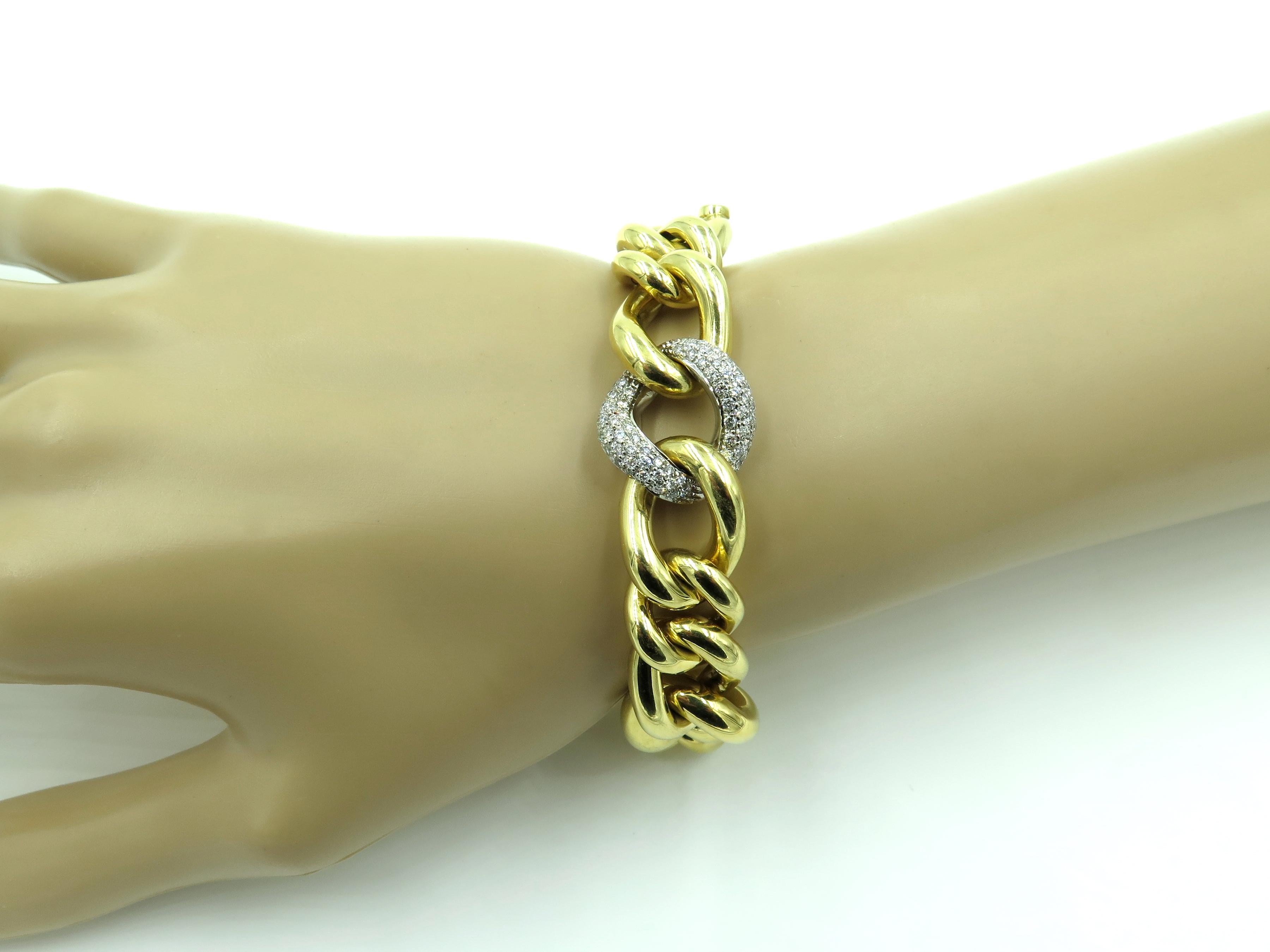 An 18 karat yellow gold, white gold and diamond bracelet. Italian. Designed as polished yellow gold curb links for various sizes, enhanced by a pave set diamond link. Seventy (70 diamonds weigh approximately 0.70 carat. Length is approximately 7 3/4