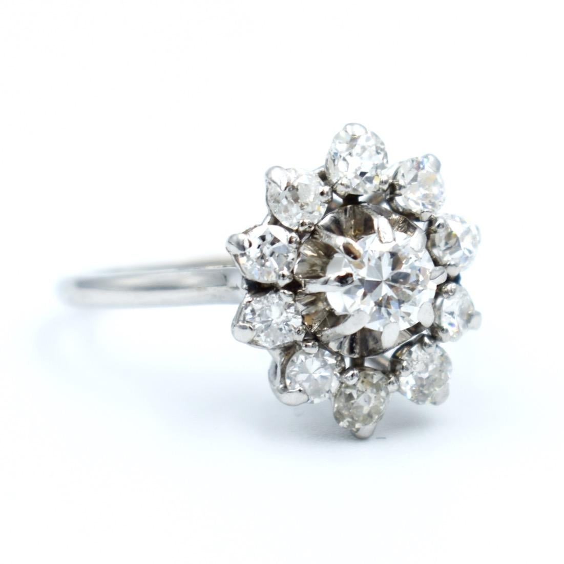 
Vintage-Ring aus 18 Karat Weißgold in Form einer Blume. Er ist mit 11 Diamanten im Altschliff und Halbschliff von insgesamt ca. 1,5 Karat VS-SI geschmückt, einschließlich des Diamanten in der Mitte von 0,30 Karat. Das Muster hat eine Gesamtlänge