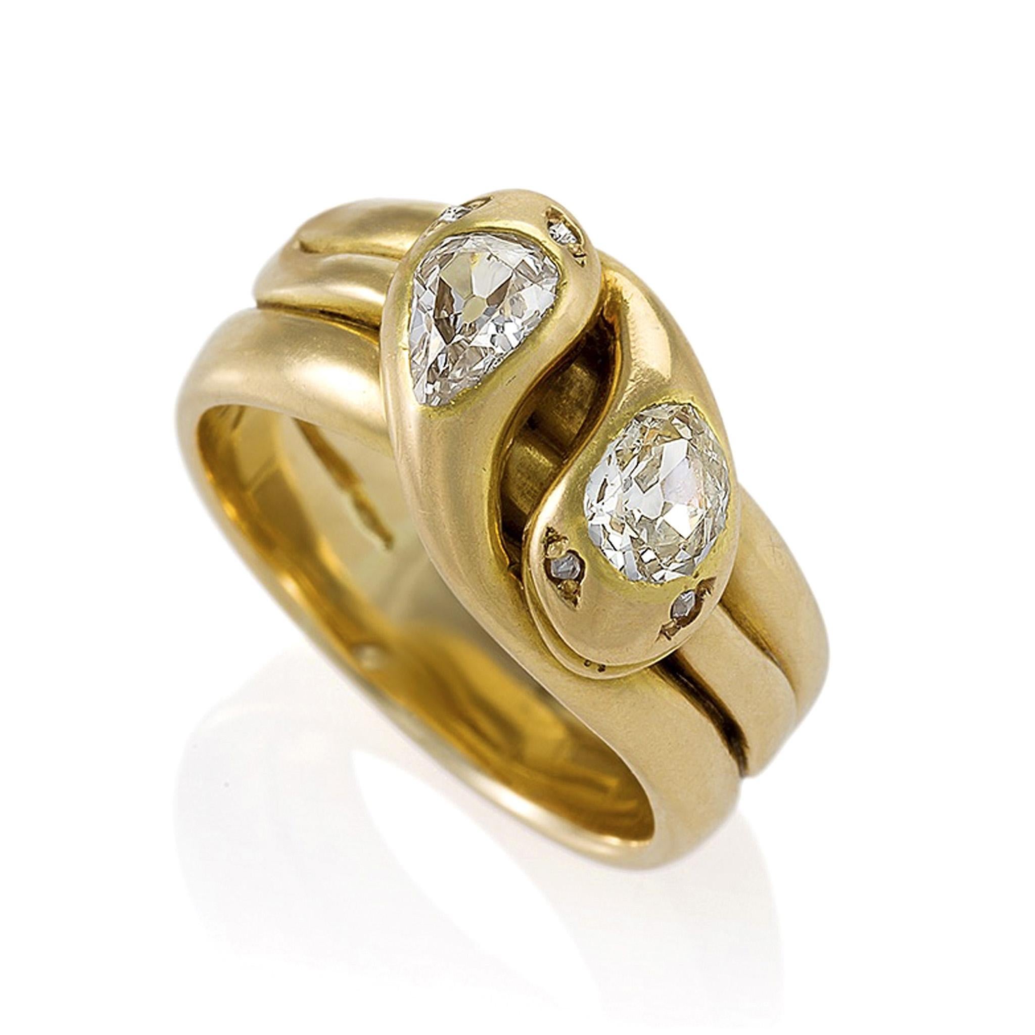 This ring is designed as gold double serpents with old pear-cut diamond heads and rose-cut diamond eyes, a Victorian design popularized by the royal wedding of Queen Victoria and Prince Albert. Give and receive these lovingly entwined serpents for