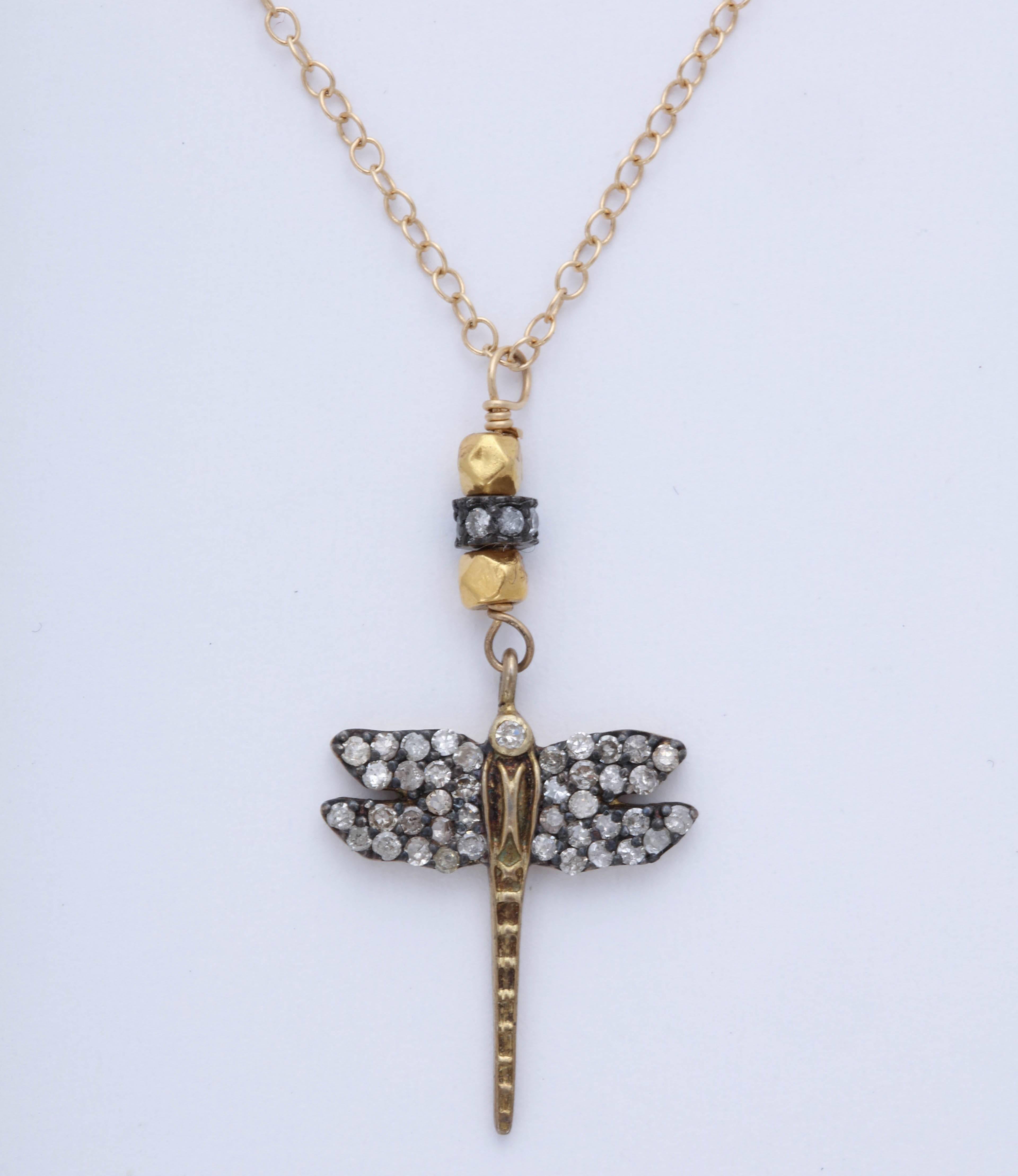 Gold, Silver and Diamond dragonfly pendant. Beautifully set and engraved.  It is 3/4 across the wings and about 1 in. long total. The chain is 18 kt. and 18 in.