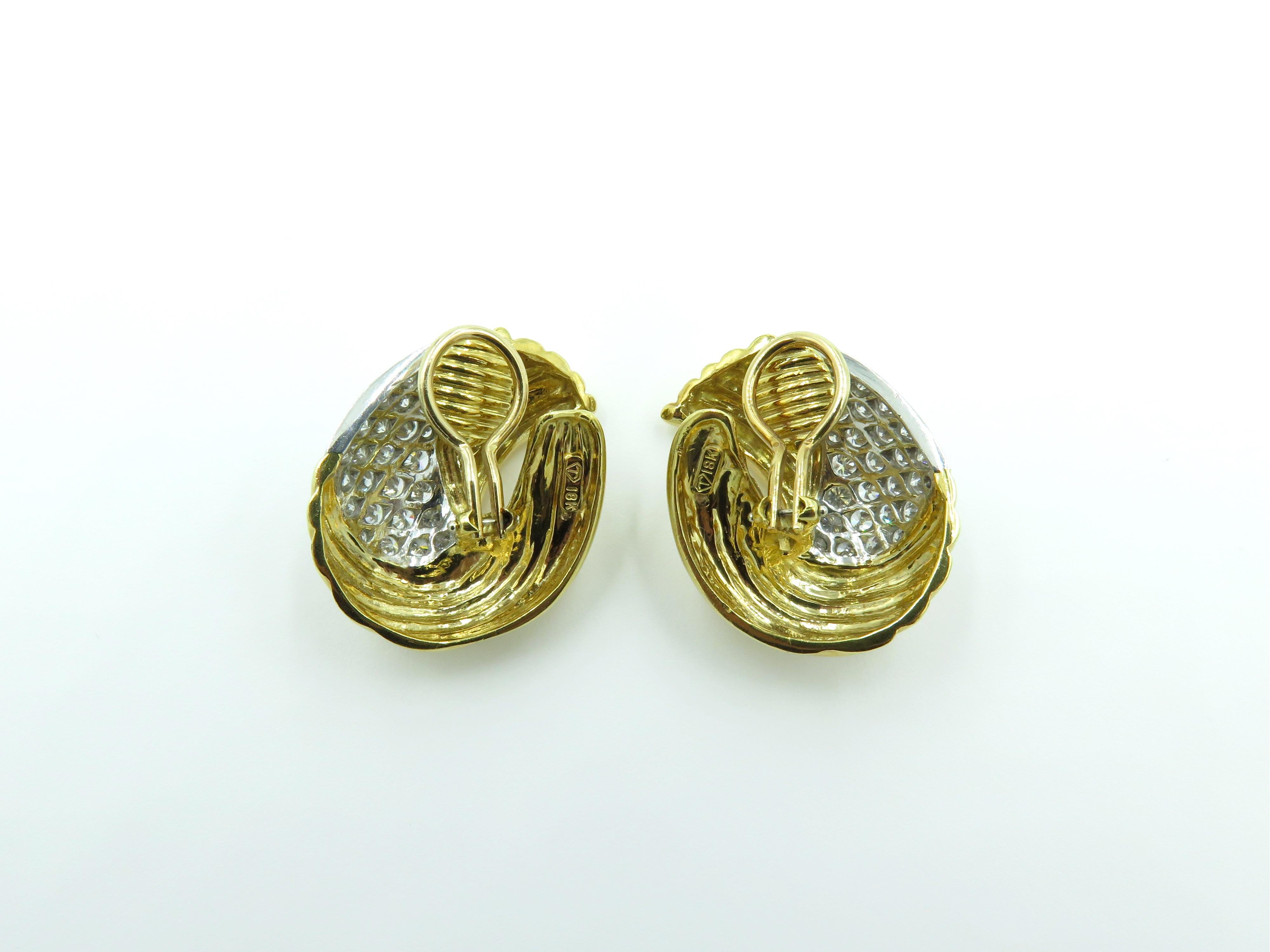 A pair of 18 art yellow gold and diamond earrings. Circa 1970. Each designed as a fluted gold spray, enhanced by pave set diamonds.  Fifty six (56) diamonds weigh approximately 3.00 carats. Length is approximately 1 1/4 inches. Gross weight is