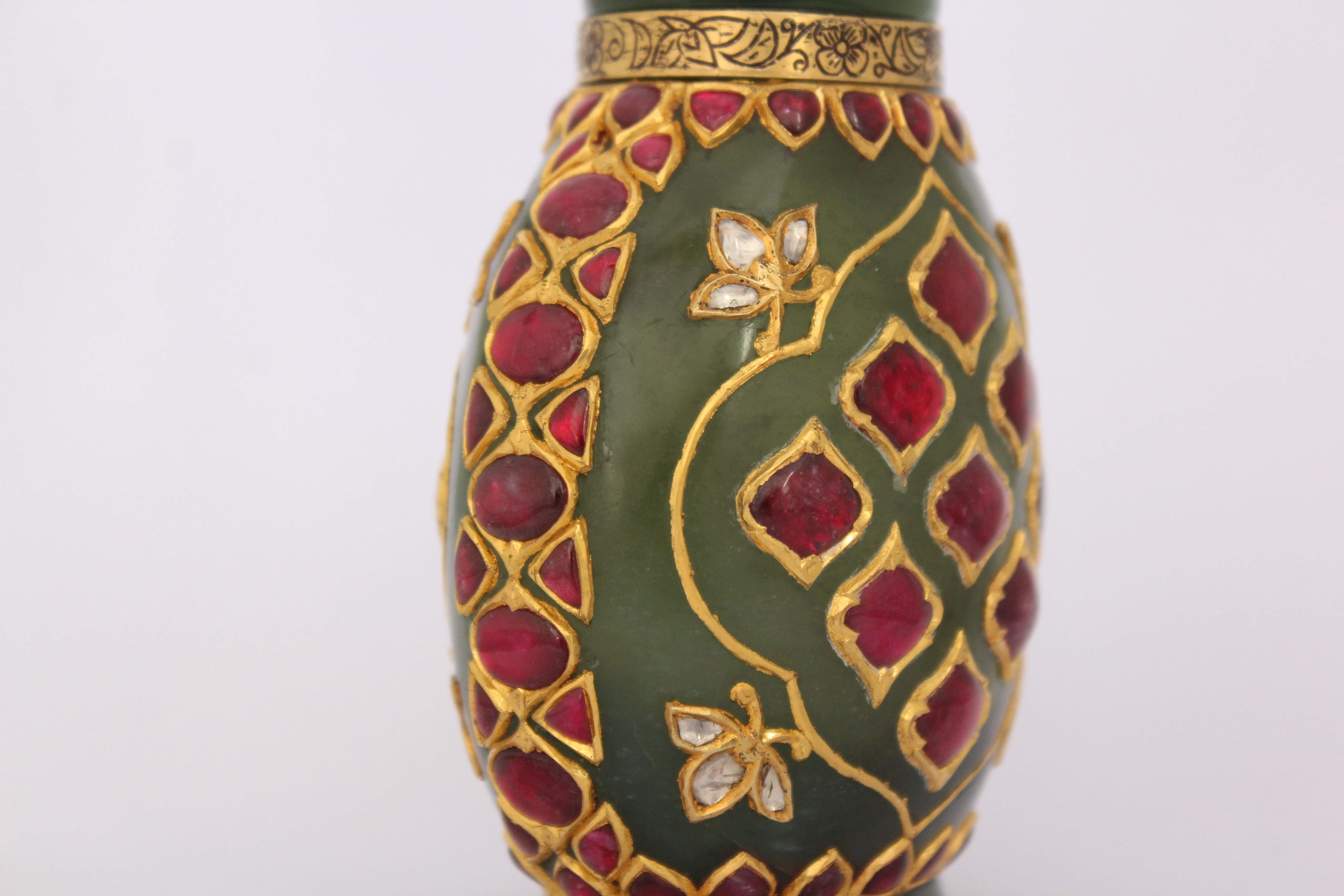 This elegant rare whiskey flask is made from one single stone and inlaid in gold, rising from short flaring foot through rounded body to slightly flaring cylindrical rim, with simple cylindrical spout, the body elegantly engraved with a 24K purity