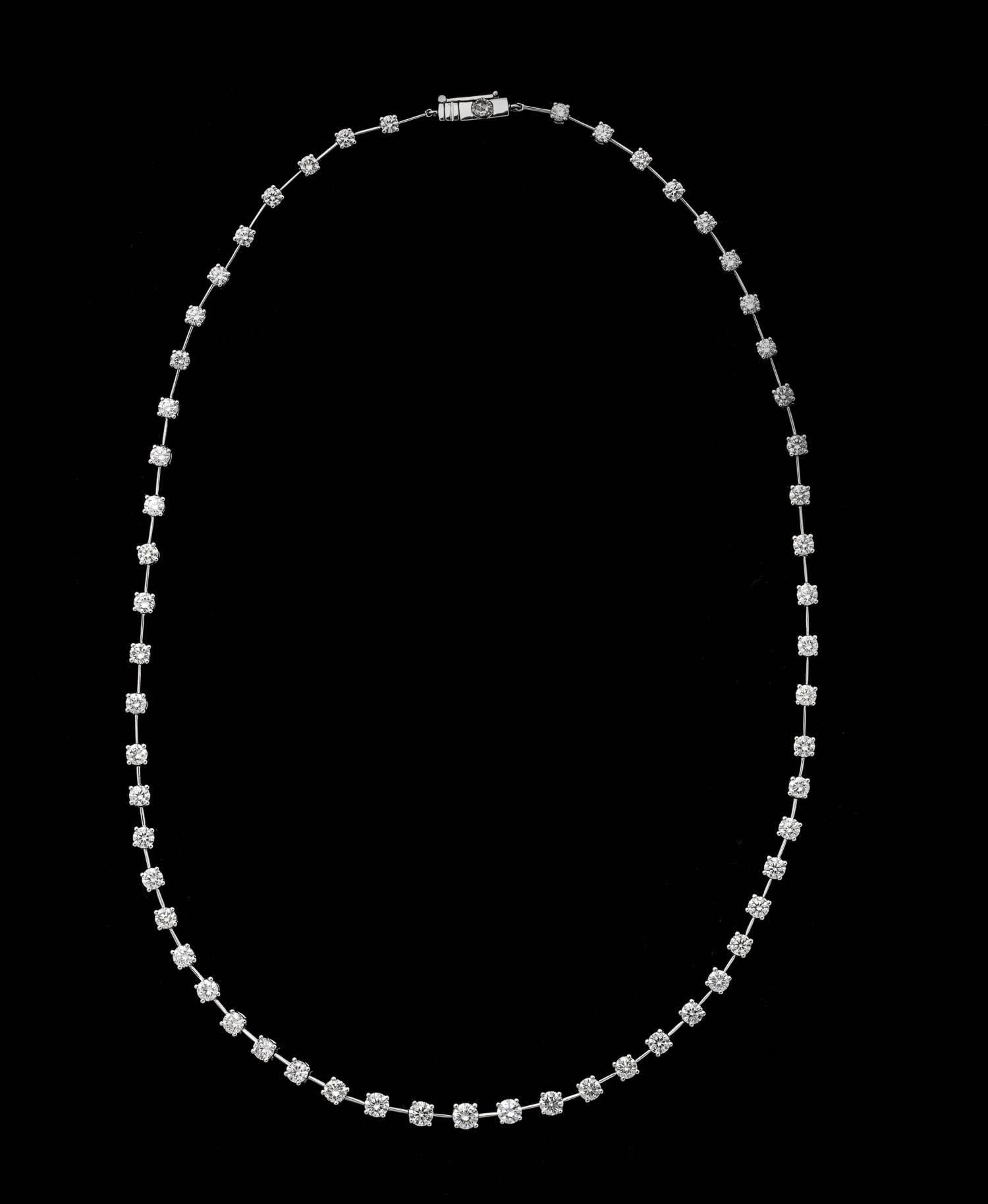 18k white gold segmented necklace ,57 full cut diamonds separated by knife edge gold links with a total weight of 6.30 carats, wonderfully flexible 16.5 grams of 18k gold