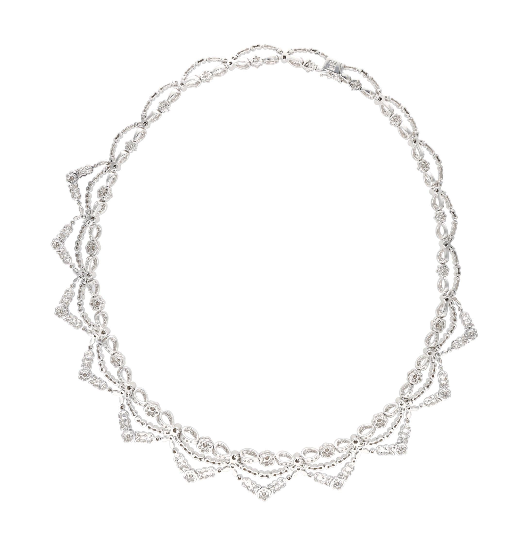 Collar necklace with floral accents set with round brilliant diamonds.

- Diamonds weigh a total of approximately 10.00 carats
- 18 karat white gold
- Total weight 58.15 grams
- Length 17 inches

The condition report is Very Good. 

Perfect for any