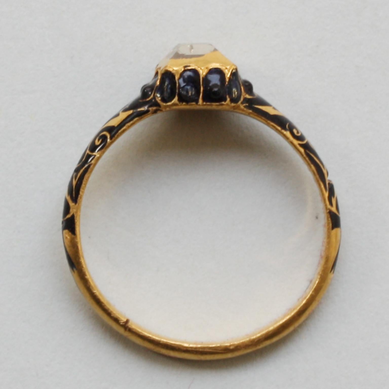 A rare gold ring with a table-cut diamond in a box setting. The shank is decorated with arabesques and foliate ornaments in dark blue champlevé enamel. Western European, circa 1600. Found in Friesland and registered with the Archeological Services