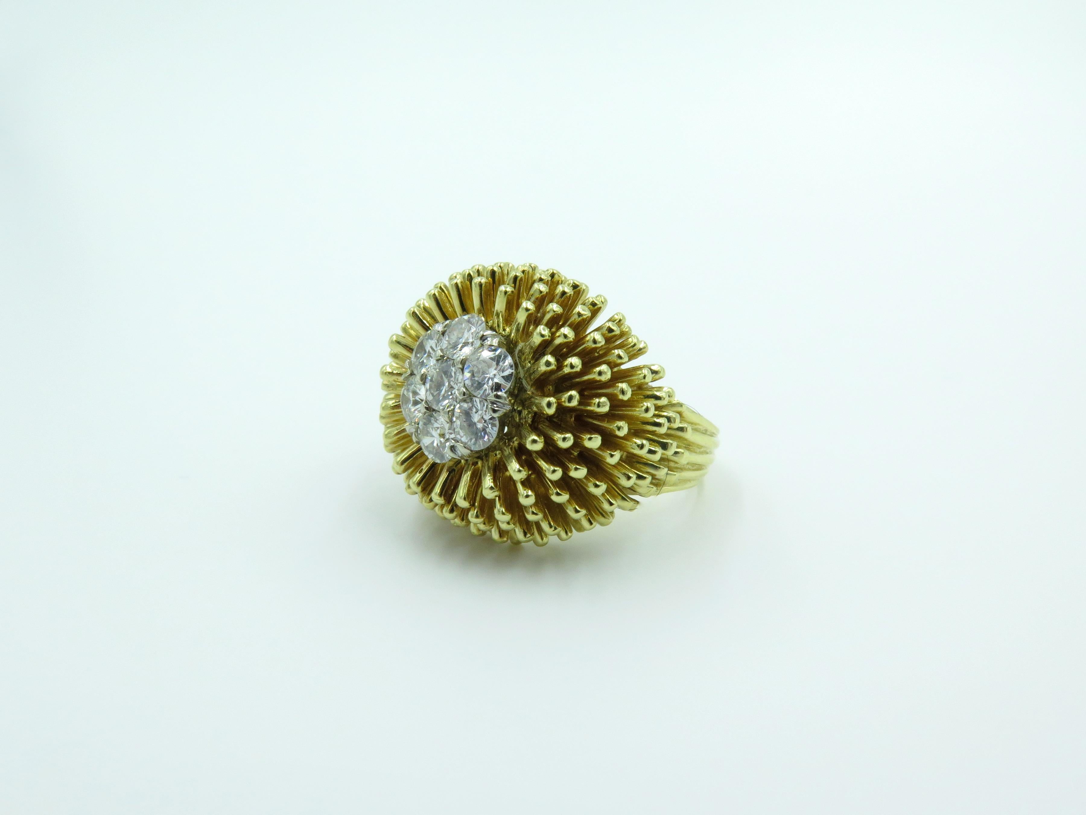 An 18 karat yellow gold and diamond ring. Circa 1960. Of sea urchin motif, centering a circular cut diamond floret. Seven (7) diamonds weigh approximately 0.90 carat. Size 5. Gross weight is approximately 14.6 grams. 