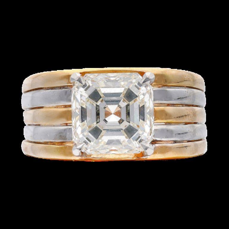 Centering a square emerald cut diamond.
Diamond weighs a total of 3.51 carats
18 karat white and yellow gold
Size 4 3/4
Total weight 11.19 grams
Accompanied by GIA report no. 2151621906, dated 7 October 2013, stating that the 3.51 carat diamond is K