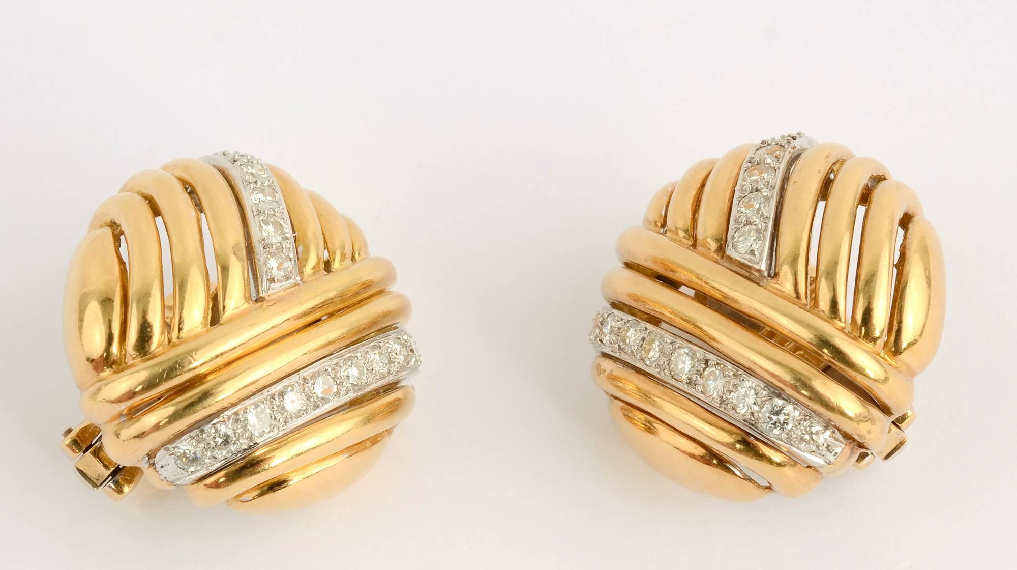 Stylish design of striated gold bands going in three directions highlighted by two rows of diamonds. The earrings are slightly domed. 
The backs are clips that can be converted to posts. Measurements are 15/16 