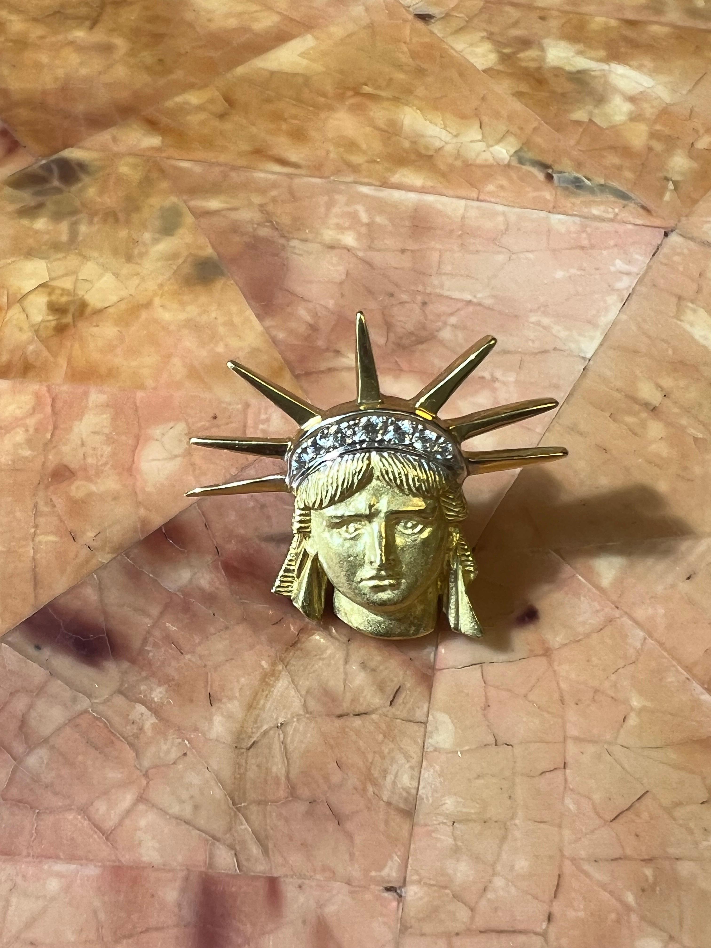 Elevate your style with our exquisite 18k Yellow Gold and Diamond Statue of Liberty Lapel Pin/Tie Tack, a true symbol of freedom and elegance. Crafted with precision and adorned with unparalleled brilliance, this accessory is designed to make a