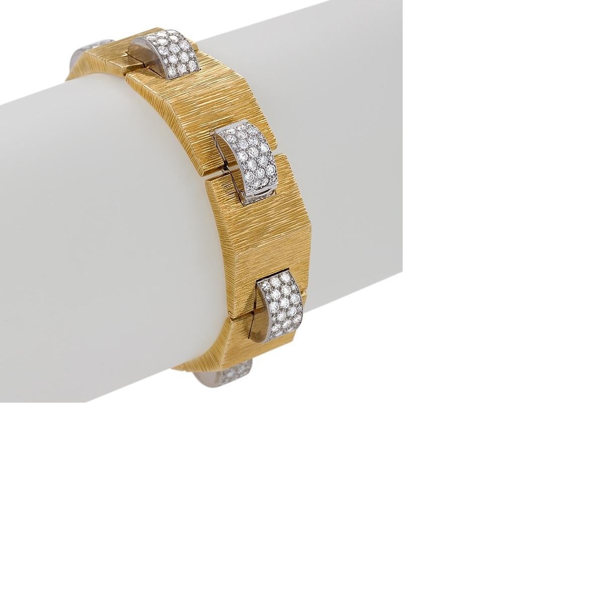 Dating from the 1940s, this striking “tank” bracelet in gold, platinum, and over four carats of diamonds is by Cartier London. Designed as a stylized version of the tank track bracelets so popular in the 1930s, it is composed of arched, striated