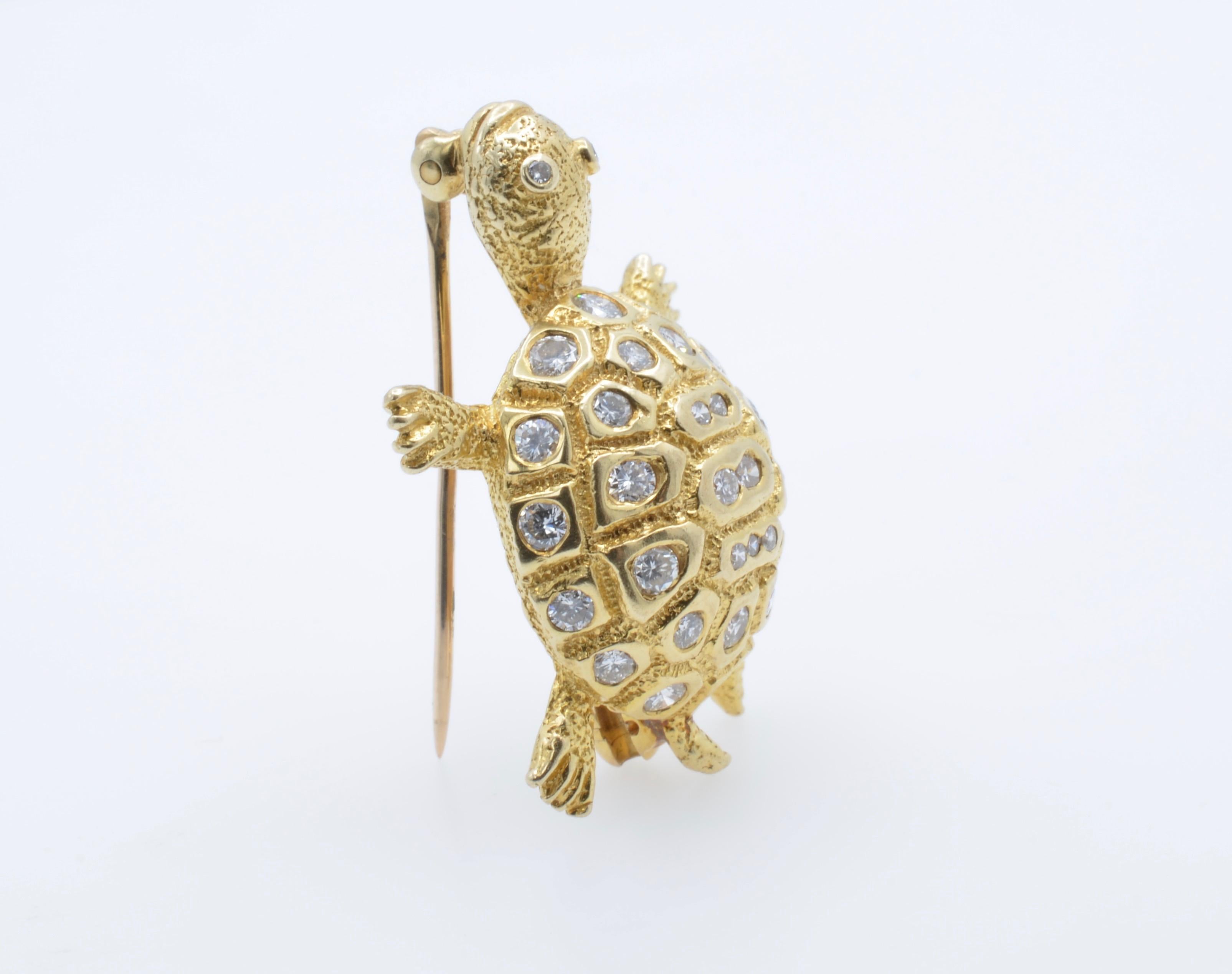 This beautiful and detailed turtle brooch glimmers with bright diamonds and intricate texture. With diamond eyes and arms spread wide this happy little  turtle looks like he's swimming with a little smile on the face. 14K yellow gold and in