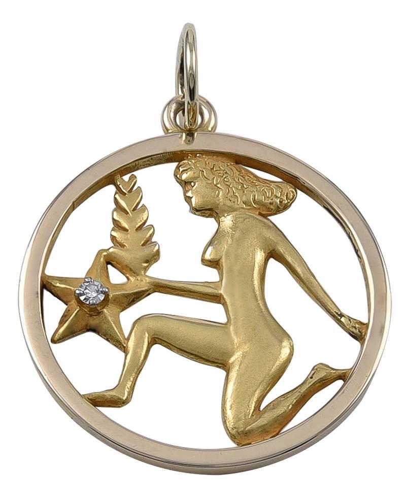 Round pendant/charm, with a cut-out depiction of VIRGO.  Set with a faceted diamond in the star.  1 1/8