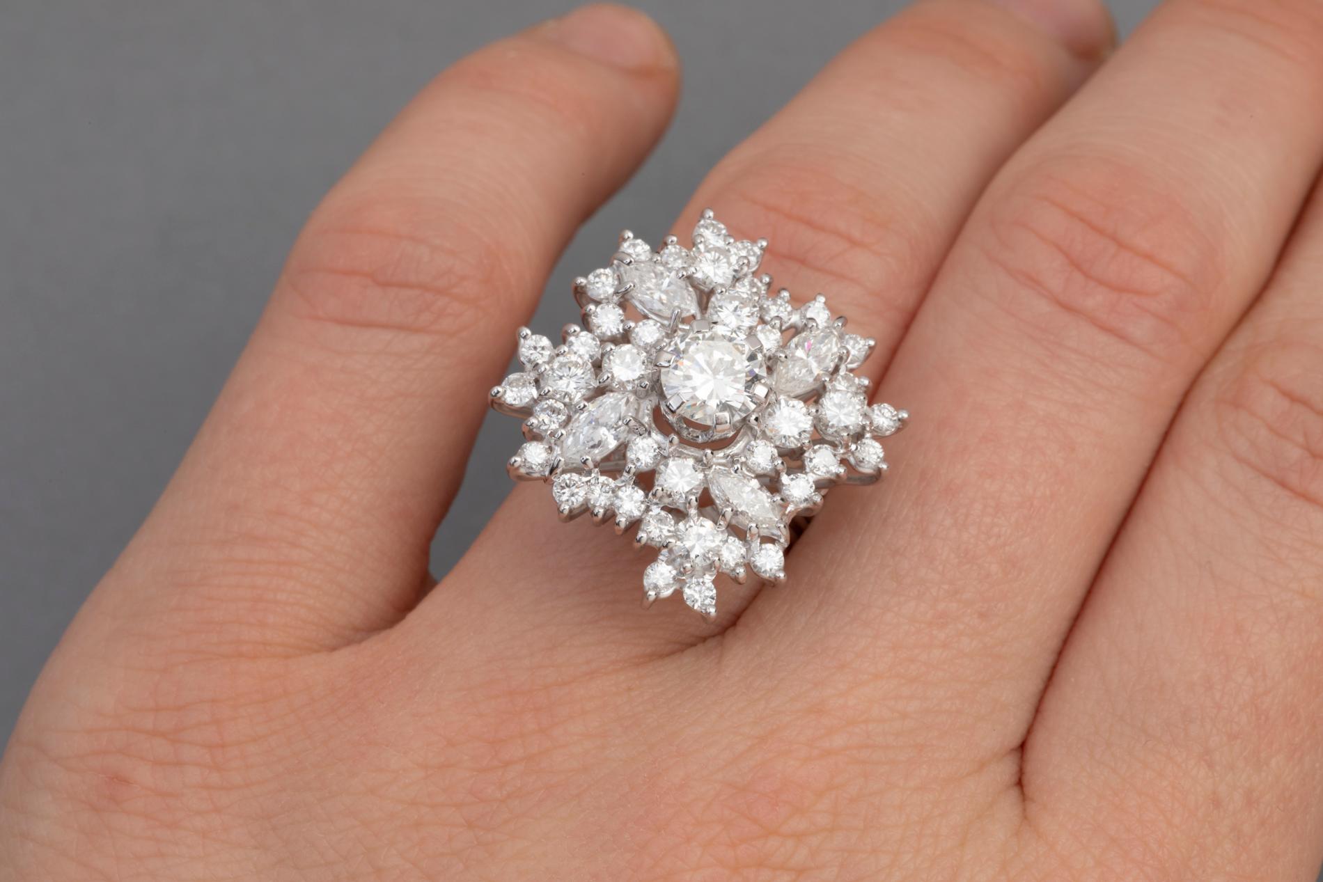 Very beautiful ring, made in France circa 1960.

the diamonds are high quality, the ring is very spectacular; The diamonds are extra white colour and good clarity.

The central diamond weight 0.85 carats estimate + 2.5 carats.

Mounted in white gold