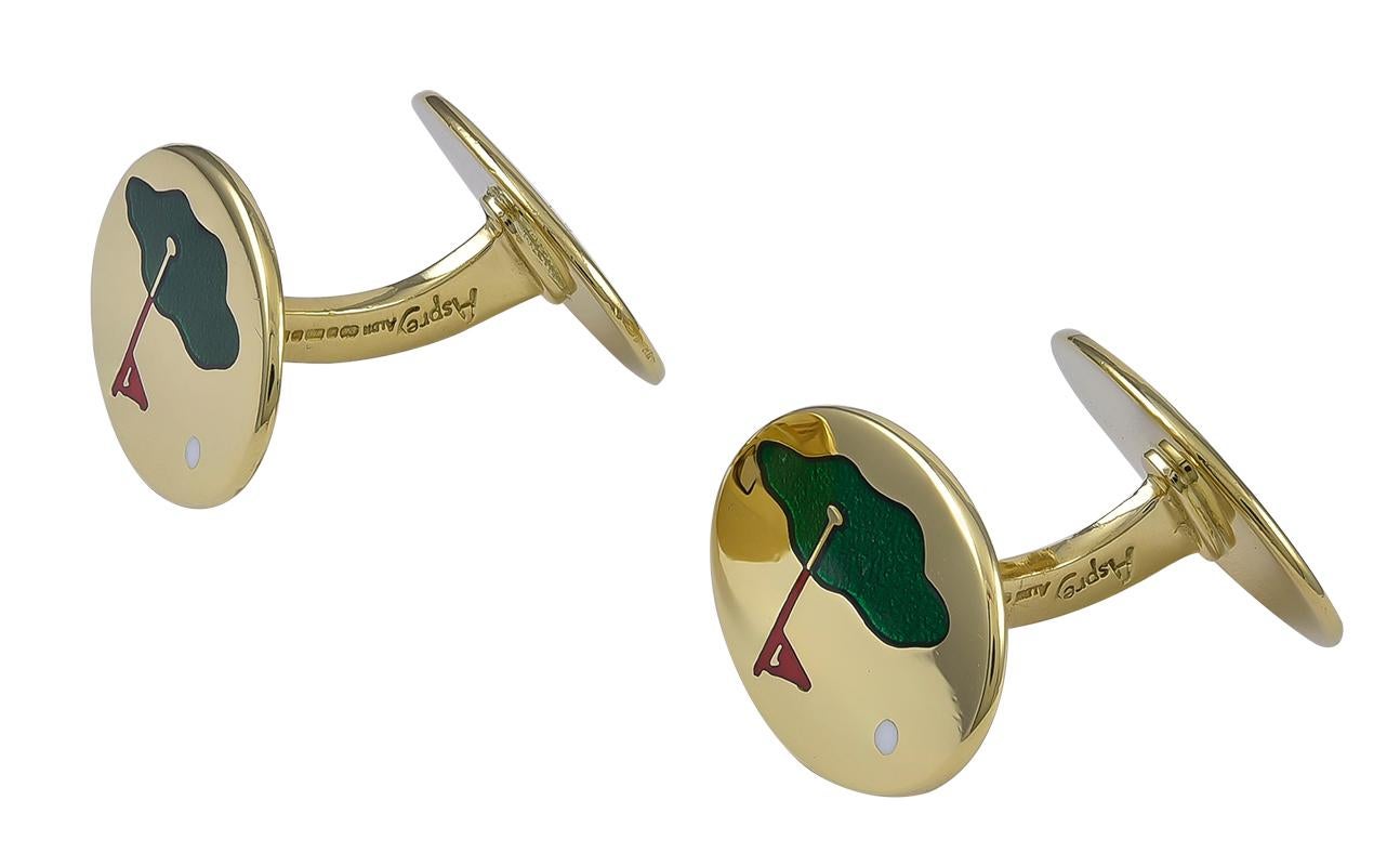 Striking double-sided cufflinks.  Made and signed by ASPREY.  18K yellow gold ovals, depicting a golf course, with a green enamel 