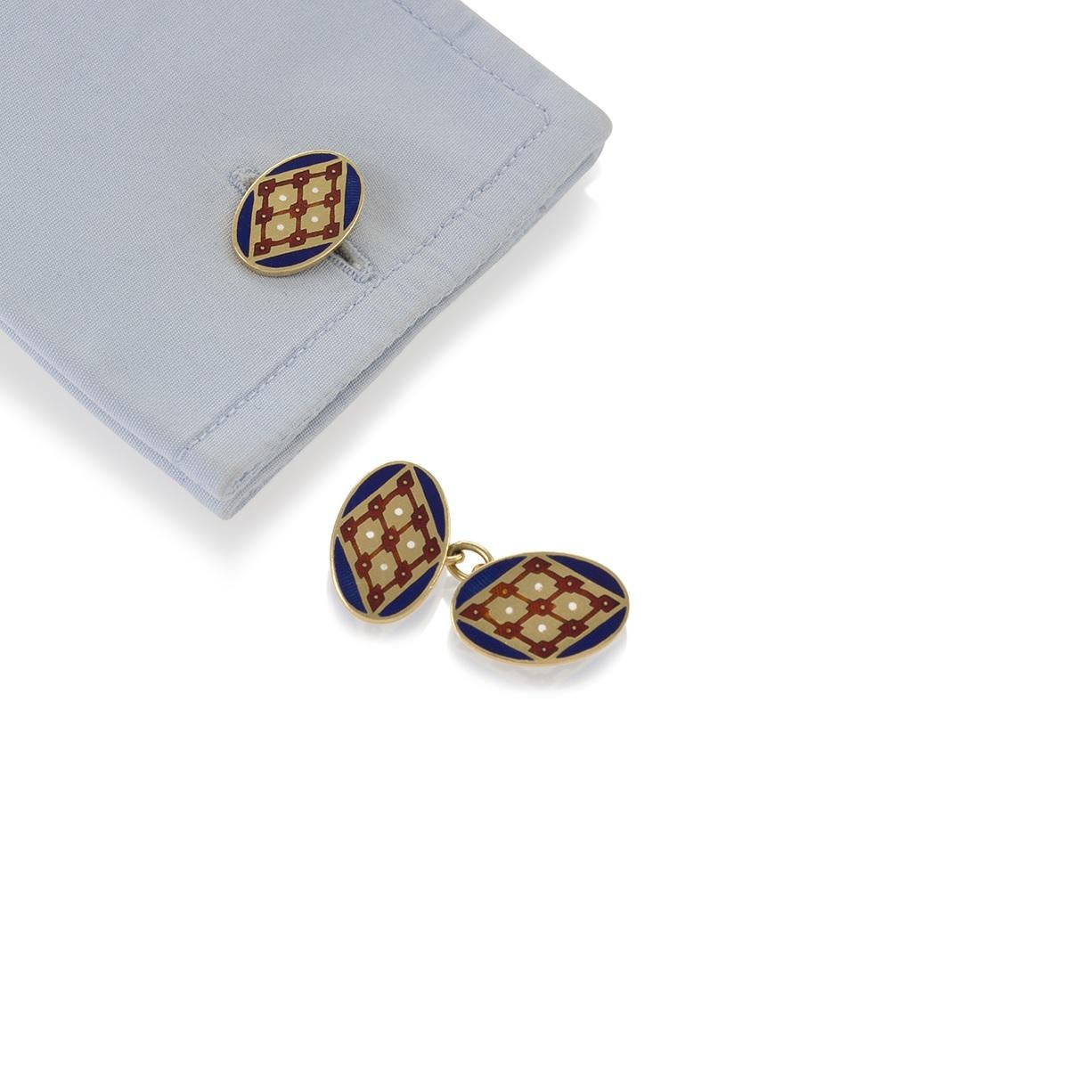 A pair of English Mid-20th Century 18 karat gold and patterned enamel cuff links in blue, red and white. Circa 1942.

Signed, JWB with Birmingham assay marks. 