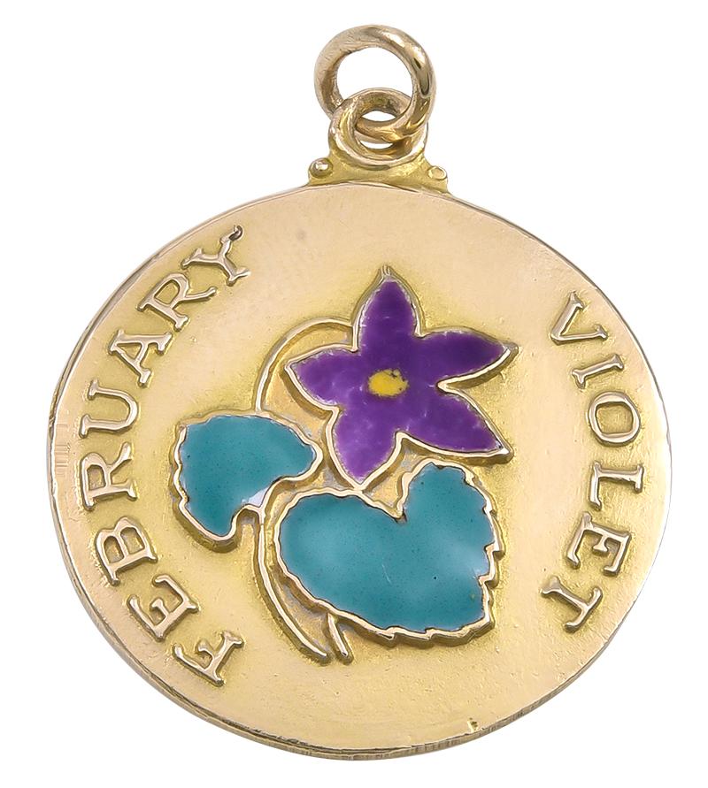 Lovely charm for a February baby:  a round disc with an applied enamel flower in the center.  Applied letters spell out 