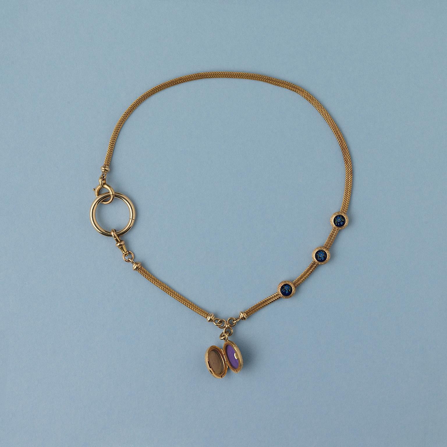 The most gorgeous 18 carat gold woven watch chain with 3 slides and a locket with two compartments decorated with forget-me-nots on both sides,  France, 19th century.

weight: 24.2 grams
length: 36.5 cm fits a small neck or 39 cm with a charm holder