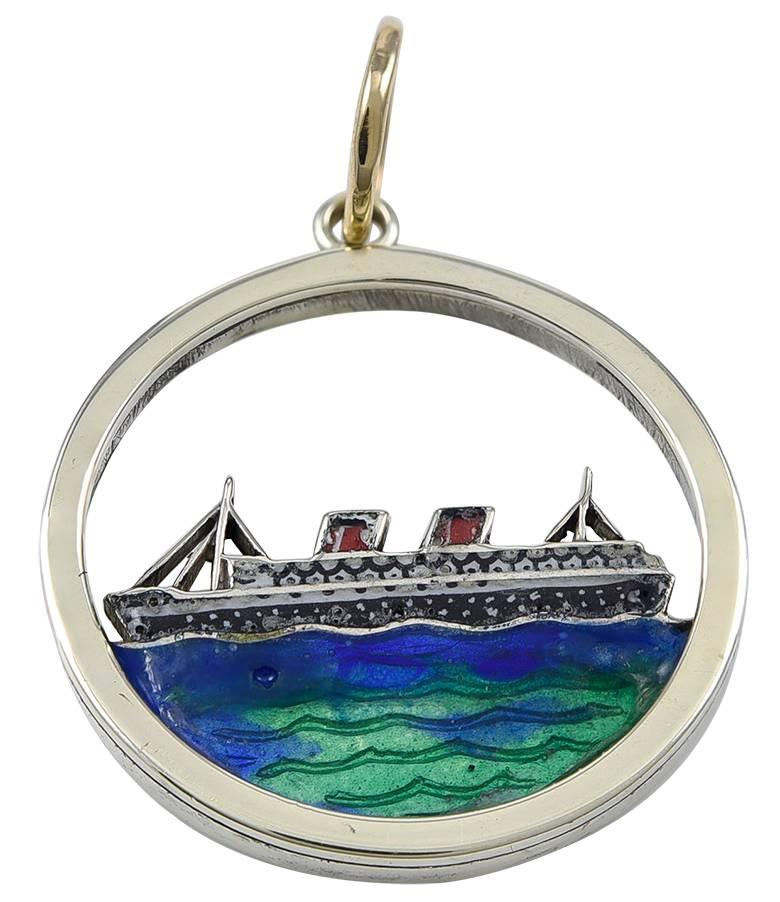 Round charm, with a cut-out depiction of the Queen Elizabeth sailing on a blue and green enamel sea.  The reverse side is engraved 
