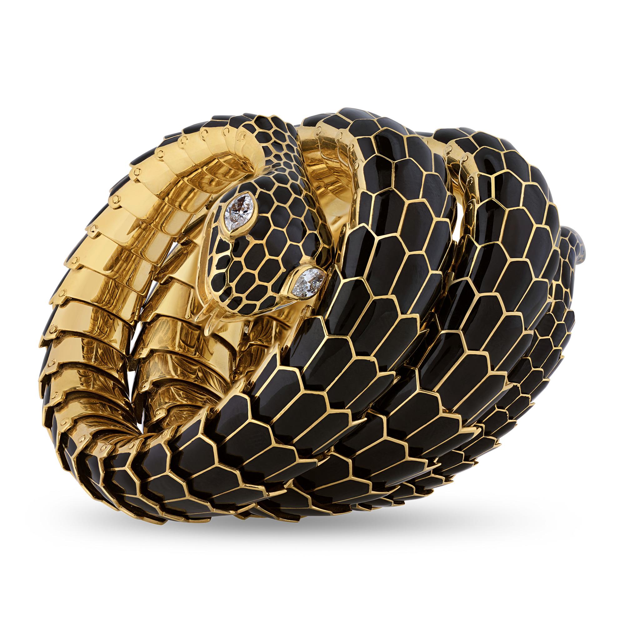 This eye-catching vintage bangle takes the form of a slithering snake. The handcrafted gold and black enamel bracelet perfectly simulates the scaly skin of the captivating reptile, and the serpent's eyes are formed of glittering marquise-cut white
