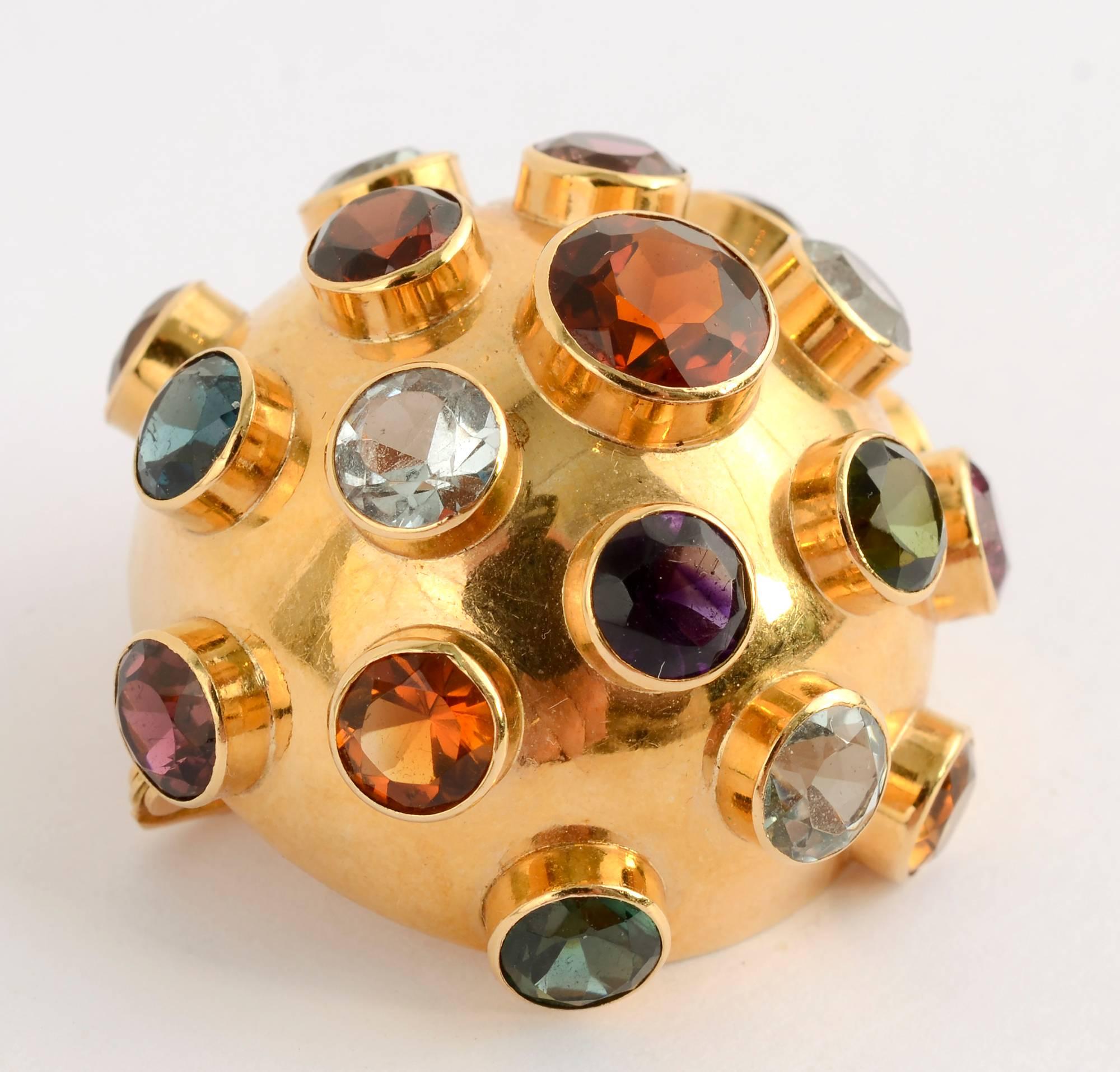 Sputnik brooch emblematic of the 1950's done in 18 karat gold with a variety of gemstones that include: citrine;garnet; tourmaline and amethyst. The half dome brooch measures 1 5/16 