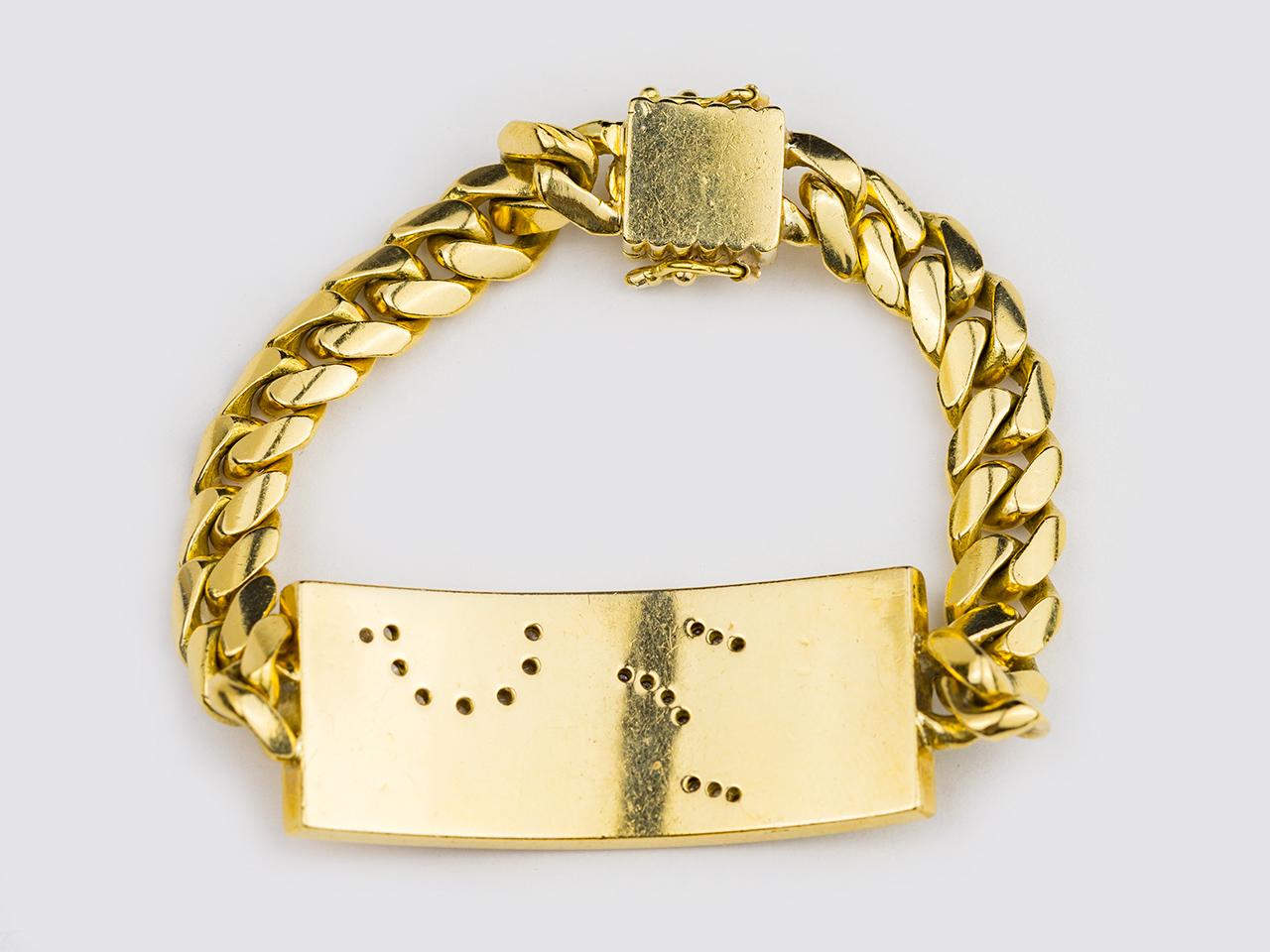 18kt gold I.D. Brace set with various hardstopnes in a flora and fauna motif.