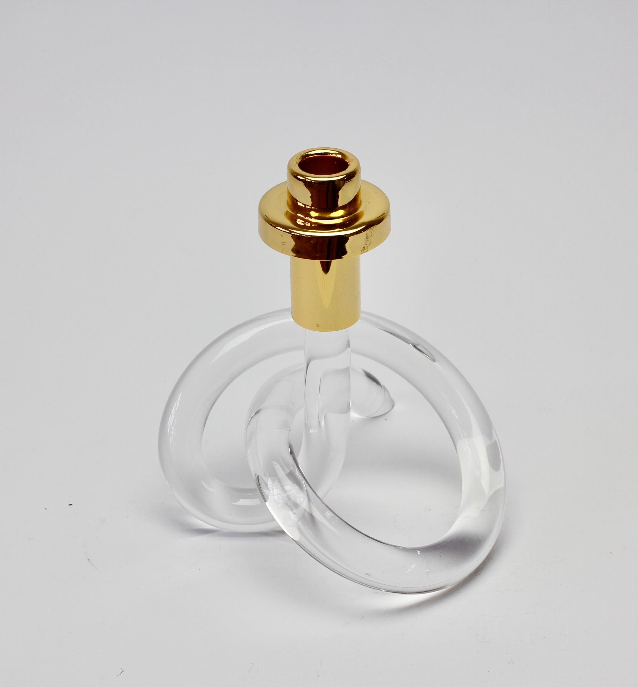 A single Lucite and gold-plated brass candlestick holder/candelabrum by American designer Dorothy Thorpe, circa 1940s. With its use of a single piece bent and twisted acrylic to form the whimsical base, it is often referred to as the 'pretzel'