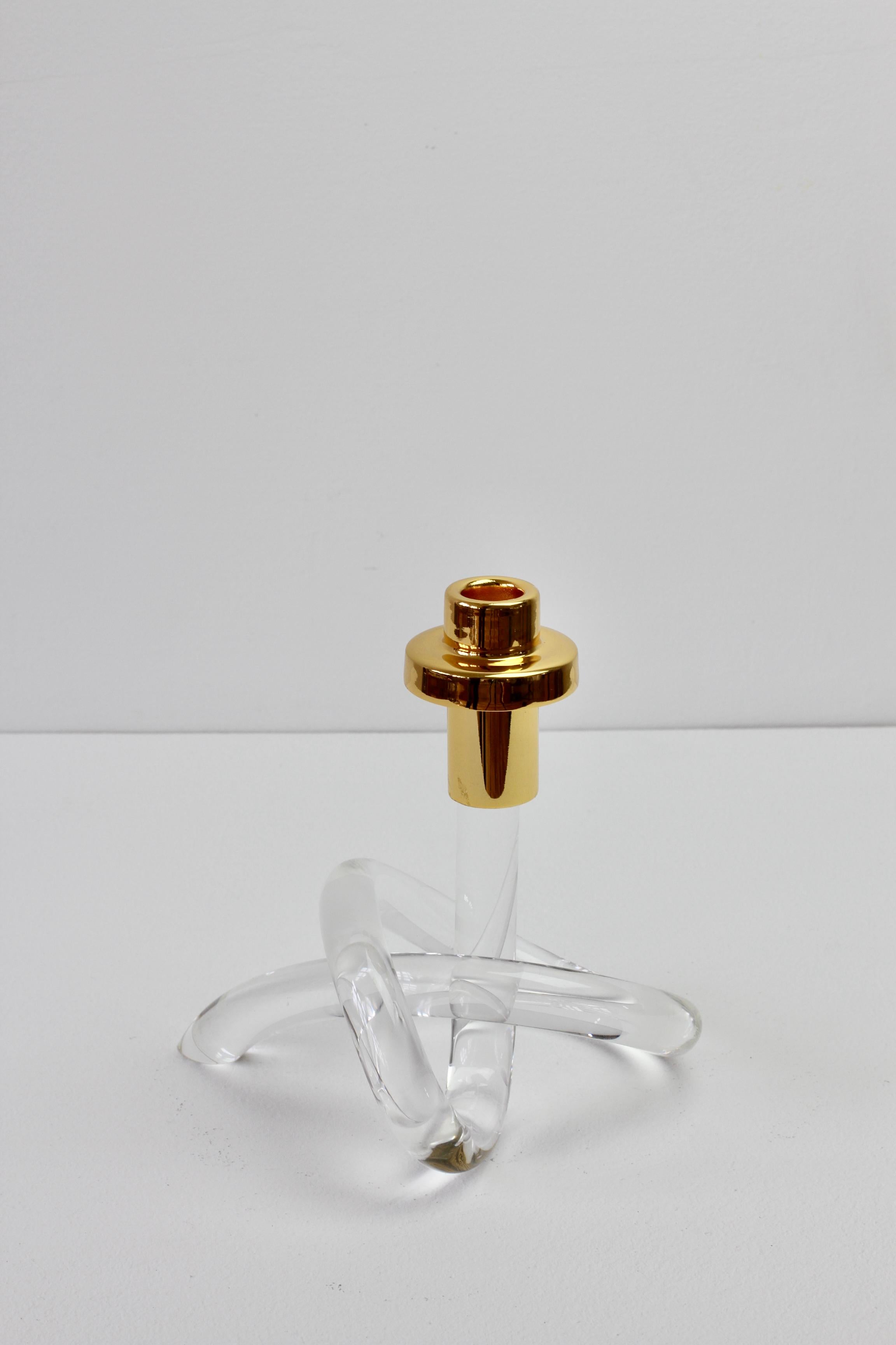 A single Lucite and gold-plated brass candlestick holder/candelabrum by American designer Dorothy Thorpe, circa 1940s. With its use of a single piece bent and twisted acrylic to form the whimsical base, it is often referred to as the 'pretzel'