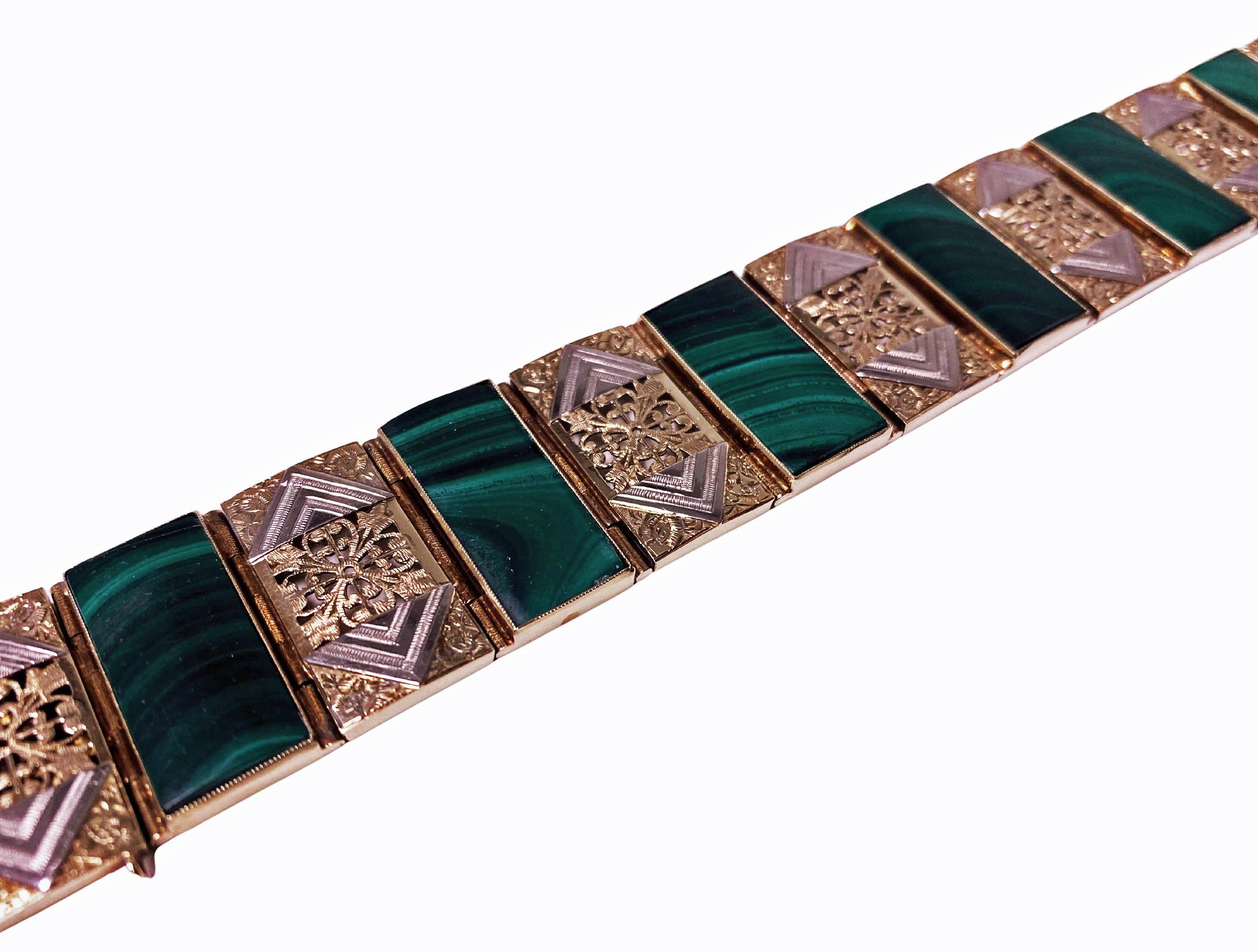 Gold and Malachite Bracelet Austria C.1970. The wide bracelet set with alternating malachite and 14K white and yellow golds pierced and lozenge panel links, terminating with tongue clasp fastener, safety catch attached. Marked with Austrian mark and
