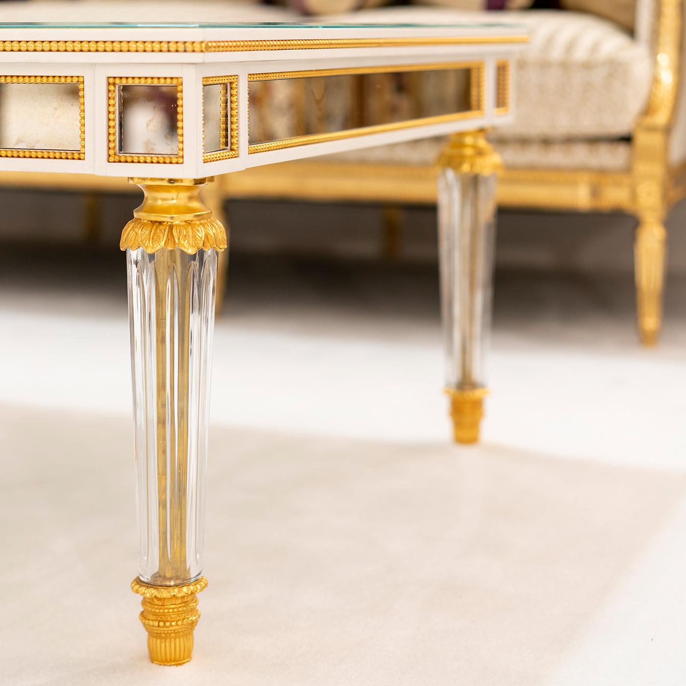 A marvelous showcase of craftsmanship that will furnish the most elegant and luxurious interior decors, this gorgeous coffee table is fashioned of arable wood enriched with 24K gold-plated bronze and crystal details. The top is covered with glass