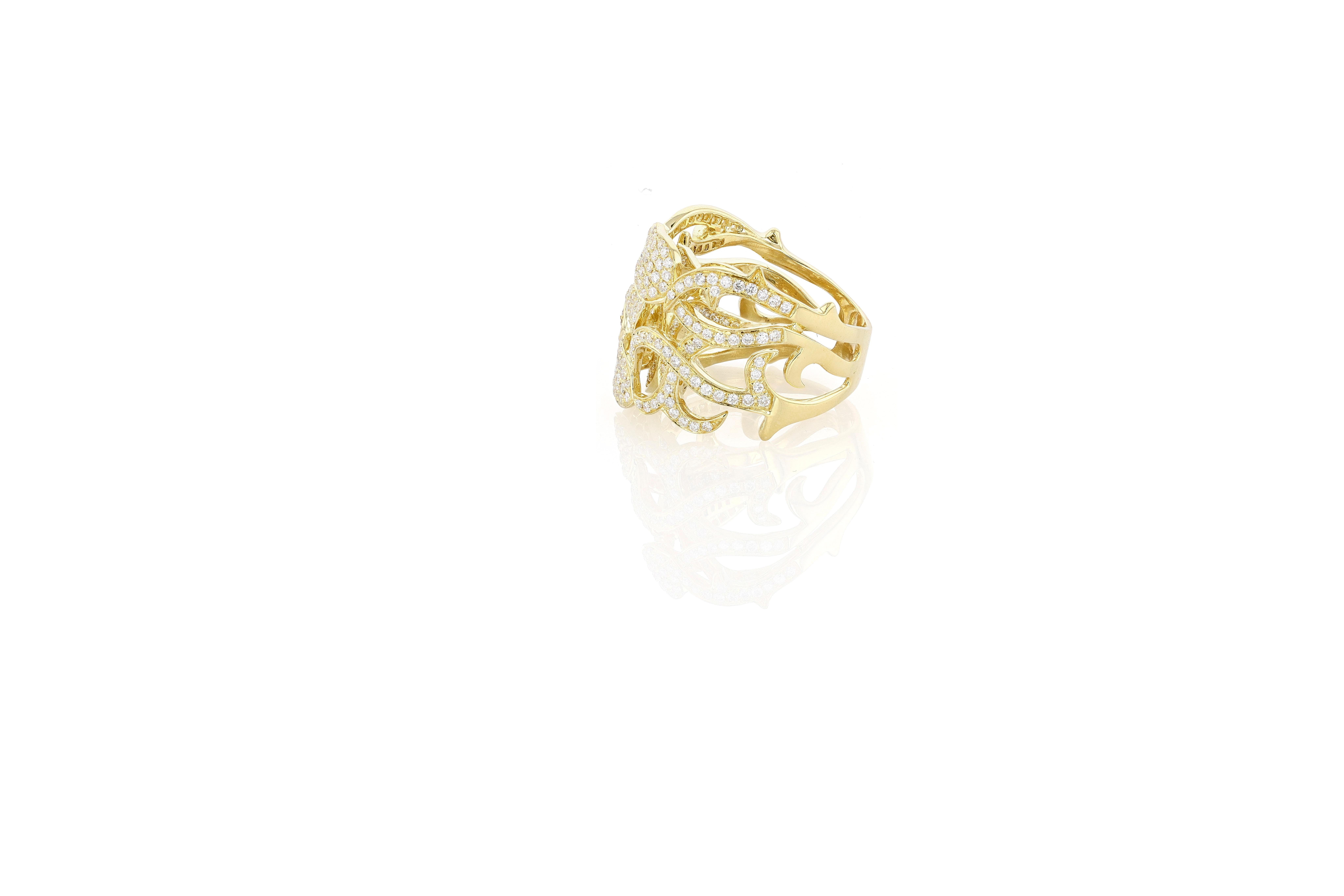 An 18 karat yellow gold and pave diamond wide band ring composed of two layers of vines and leaves fully pave set with round brilliant diamonds. The bottom of the ring is simple high polish gold with no stones. The ring is currently a size