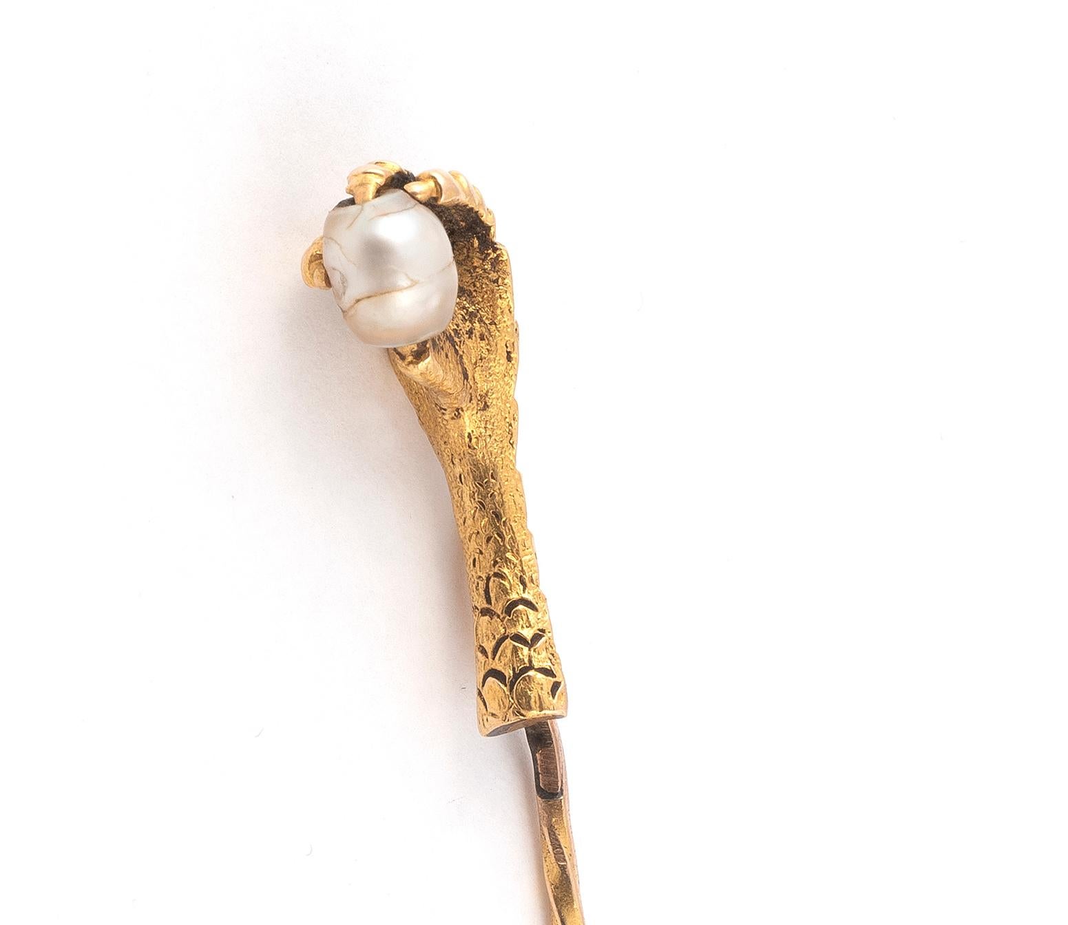 
Pearl-set stickpin set within a realistic claw mount