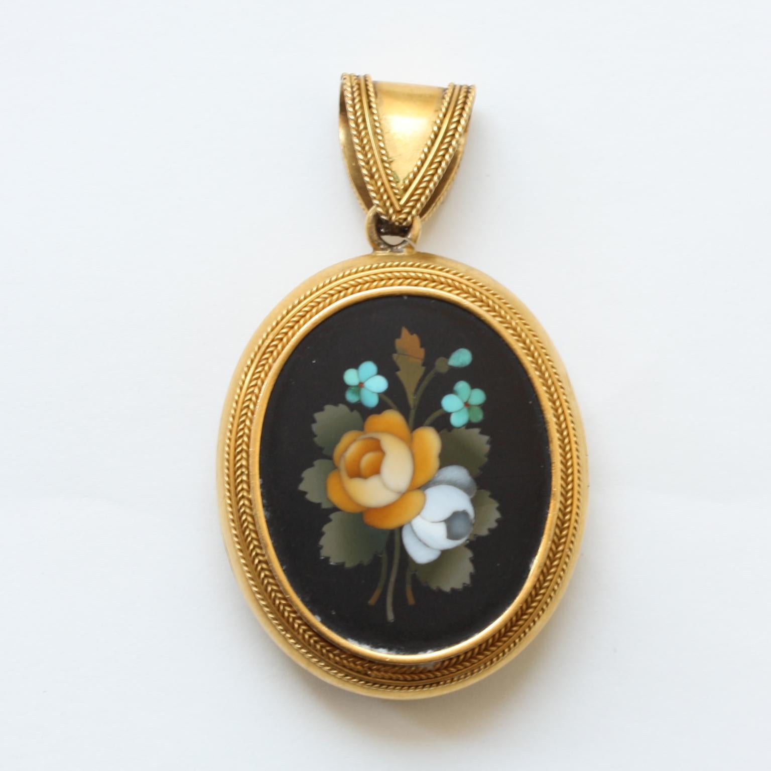 An 18 carat gold locket in neo etruscan style with a Florentine pietra dura with a different bouquet of flowers on each side, one glassed compartment, 19th century.

dimensions: 5 x 3 cm
weight: 24 grams